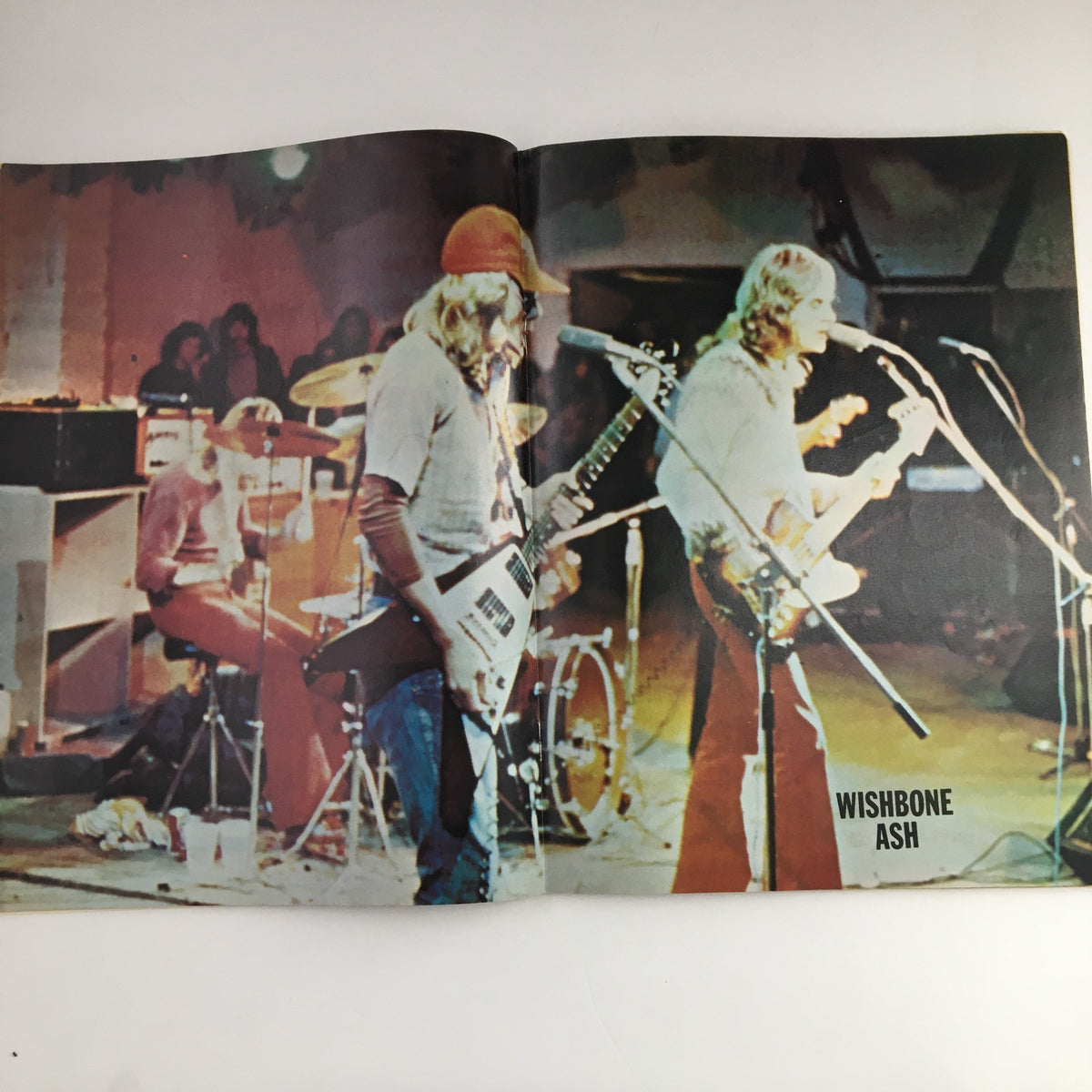 Live performance imagery of Wishbone Ash featured in the Hit Parader Songs & Stories October 1973 magazine, capturing the essence of 70s rock music.