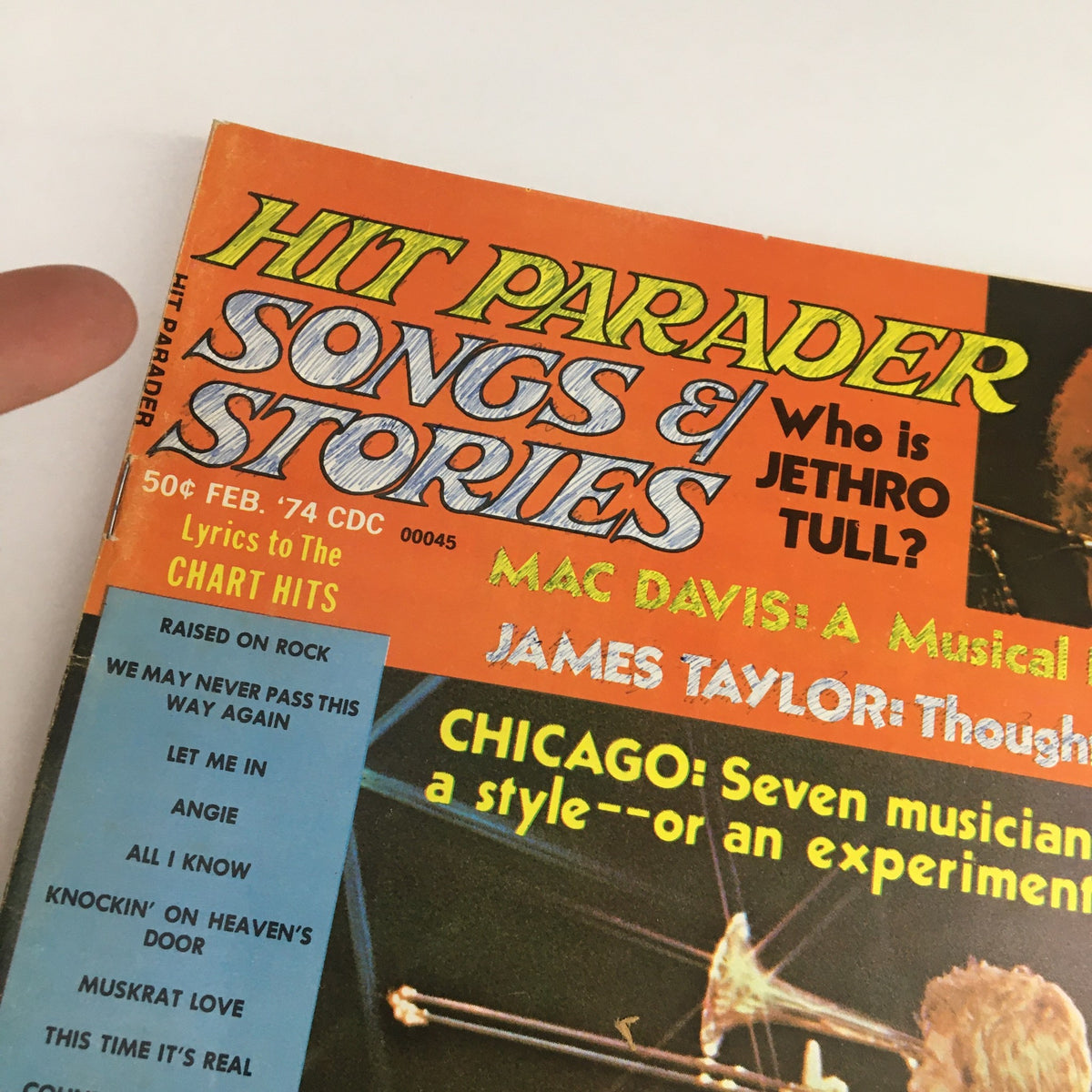 Close-up of the top section of Hit Parader Songs & Stories February 1974 magazine, showcasing headlines including 'Who is Jethro Tull?' and features on Mac Davis and James Taylor.