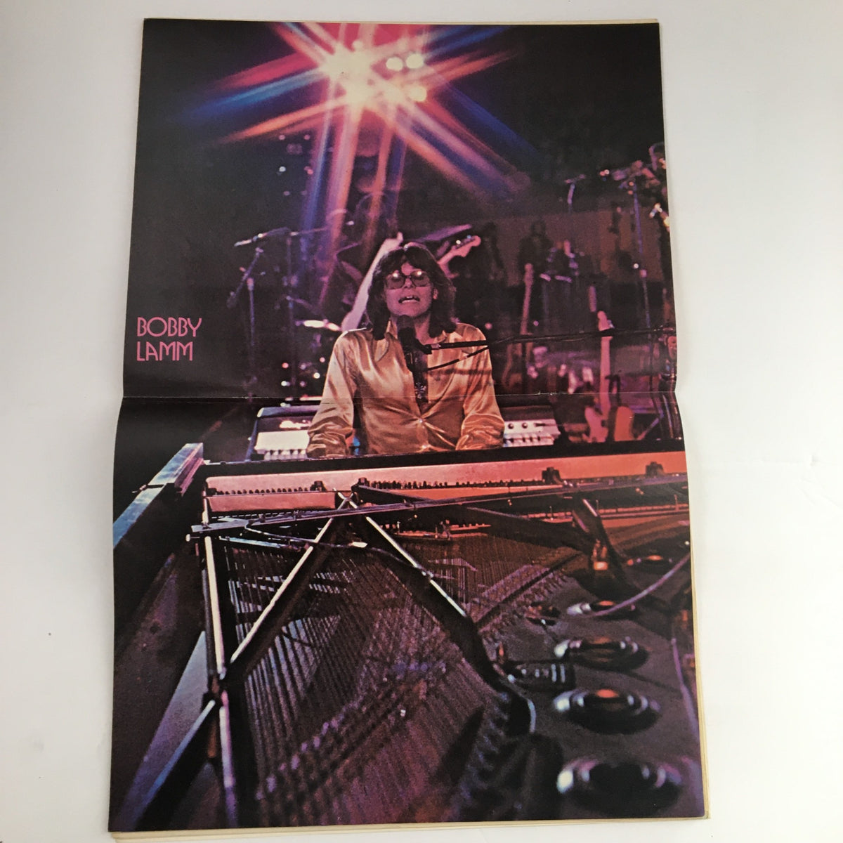 Fold-out poster of Bobby Lamm from Hit Parader Songs & Stories, February 1974, showcasing him at a keyboard with vibrant stage lights in the background.