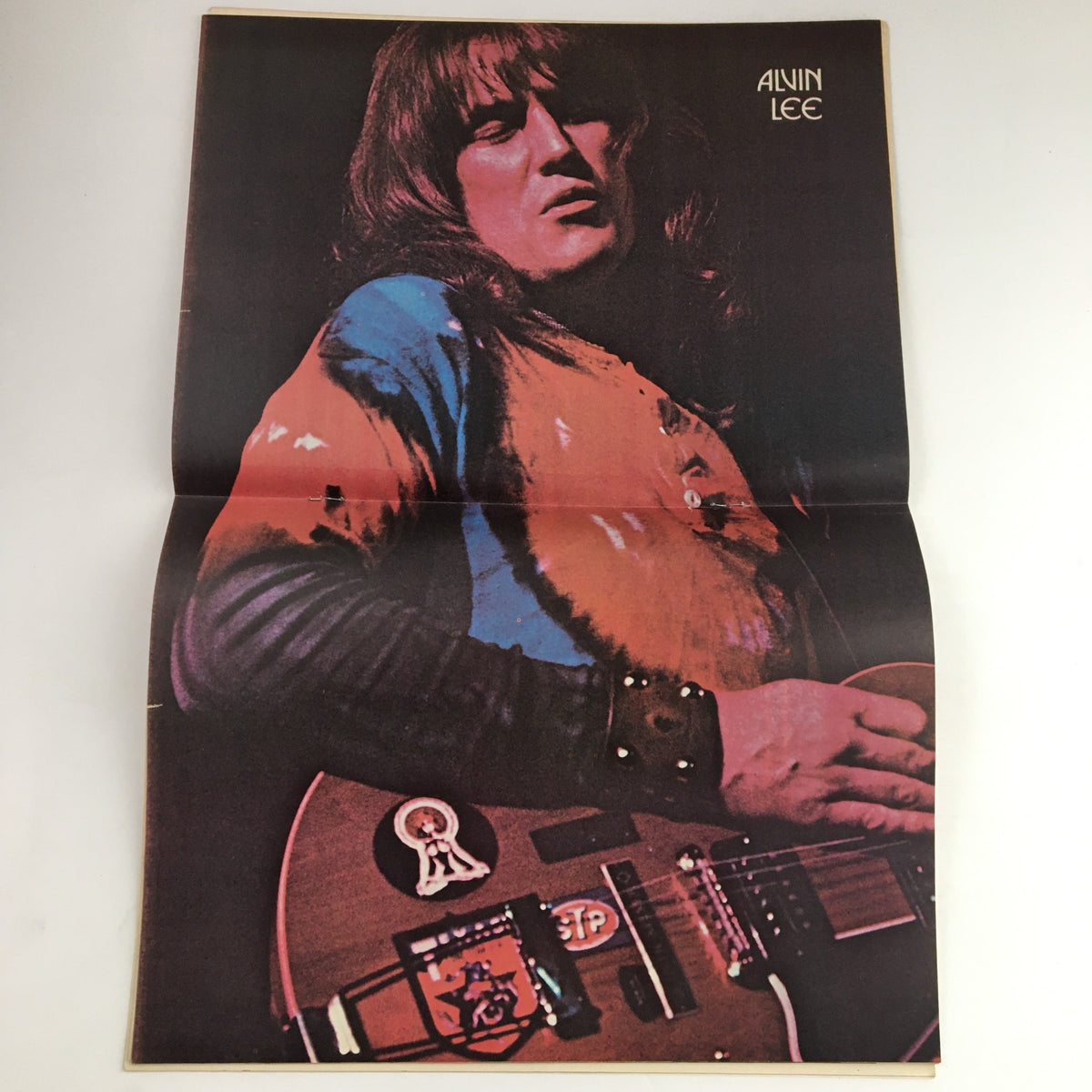 Alvin Lee featured in Hit Parader Songs & Stories April 1974 magazine, showcasing the iconic musician holding a guitar, with vibrant colors highlighting the era's rock culture.