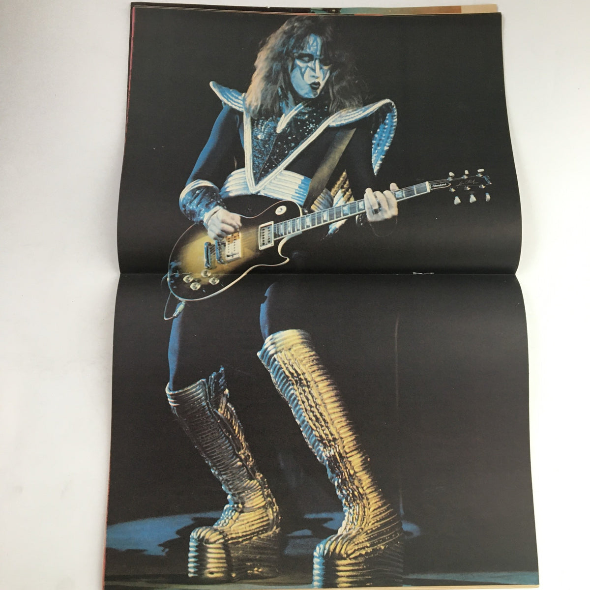 Fold-out poster from Hit Parader Magazine July 1977 featuring a guitarist in a flamboyant costume, showcasing the vibrant rock culture of the 1970s.
