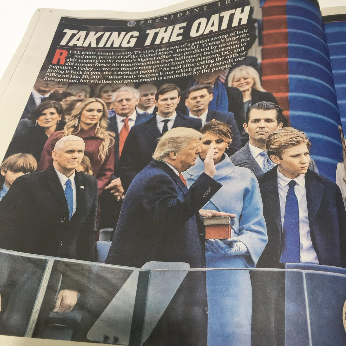 Interior page of NY York Post: January 2017, showing Donald Trump taking the oath of office with his family and officials present.