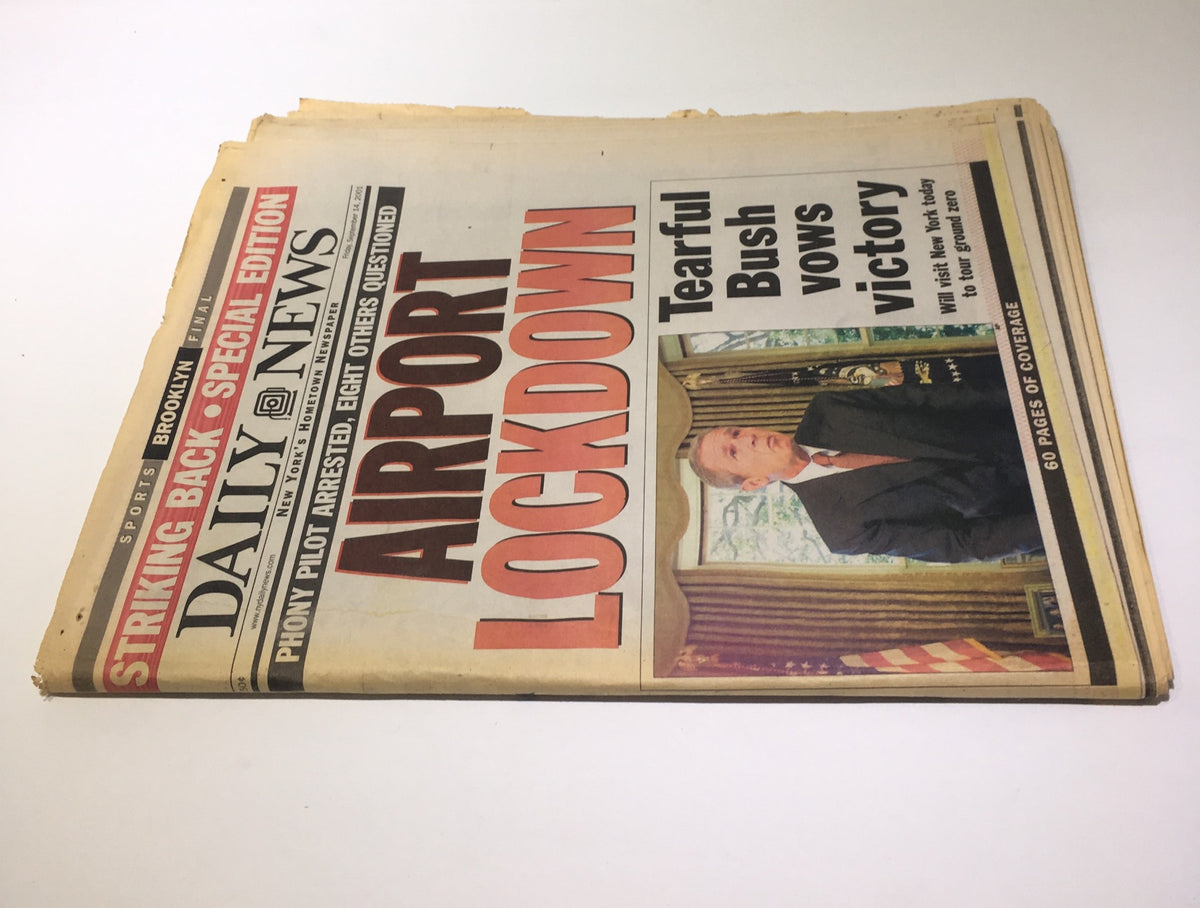NY Daily News front page from September 14, 2001, featuring the headline 'Airport Lockdown' and a photograph of a tearful President Bush vowing victory. The newspaper reflects the events surrounding 9/11 and is in good condition with some signs of age.