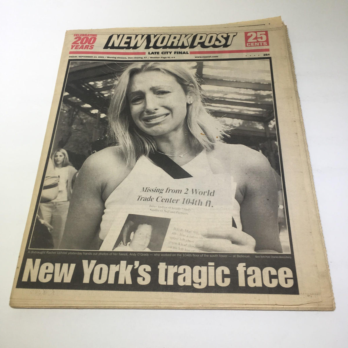 New York Post: Sept 14 2001, New York's Tragic Face featuring a woman in distress holding a photo of a missing person after the September 11 attacks.