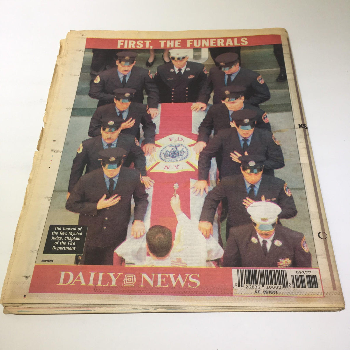 New York Daily News themed cover titled 'FIRST, THE FUNERALS' highlighting a solemn event with police officers in attendance.
