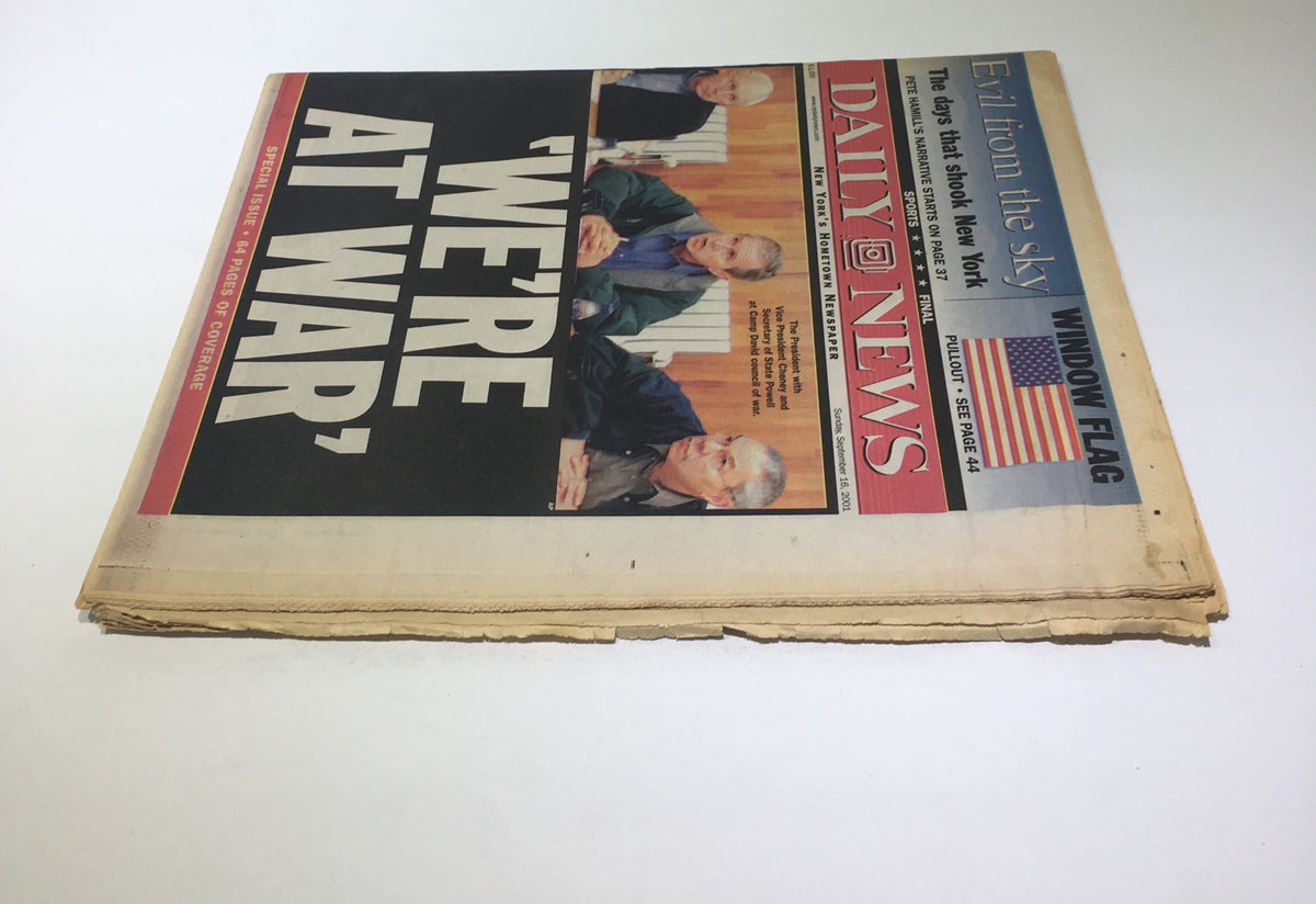 Another angle of the front page of the New York Daily News, emphasizing the headline 'WE'RE AT WAR' and images of discussions among political leaders.