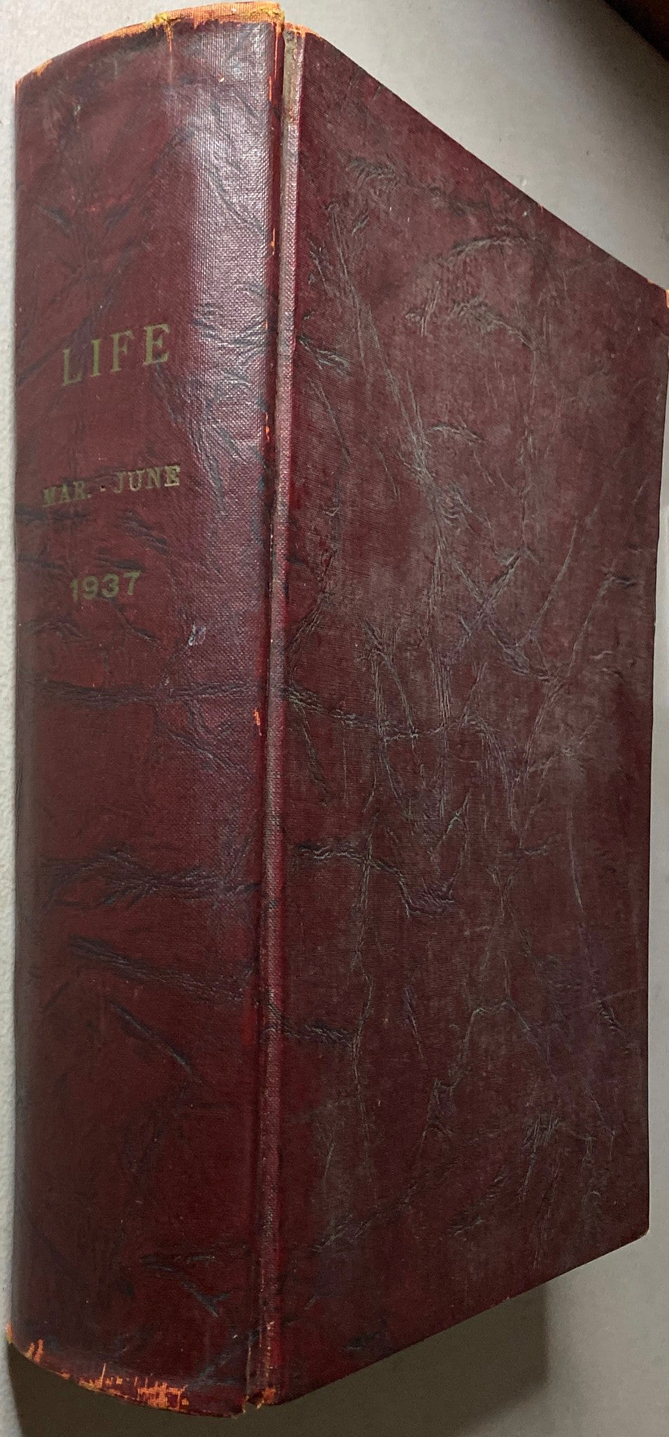 Side angle of the VTG 1937 Bound Life Magazine March - June Weekly Issue, highlighting its vintage maroon cover with gold lettering.