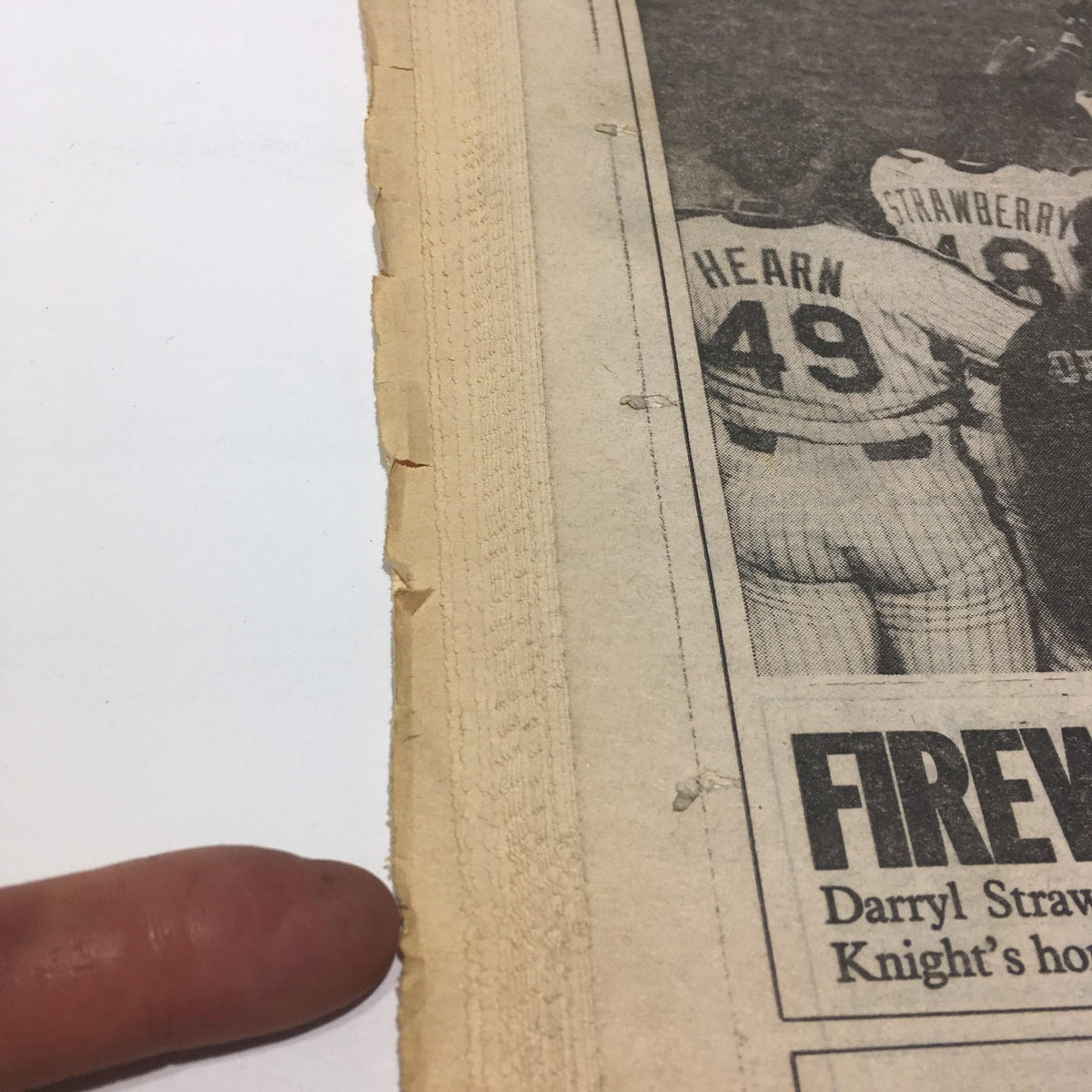 Close-up view of the edge of the July 4, 1986 Ny Daily News, showing the newspaper's wear and tear over time.