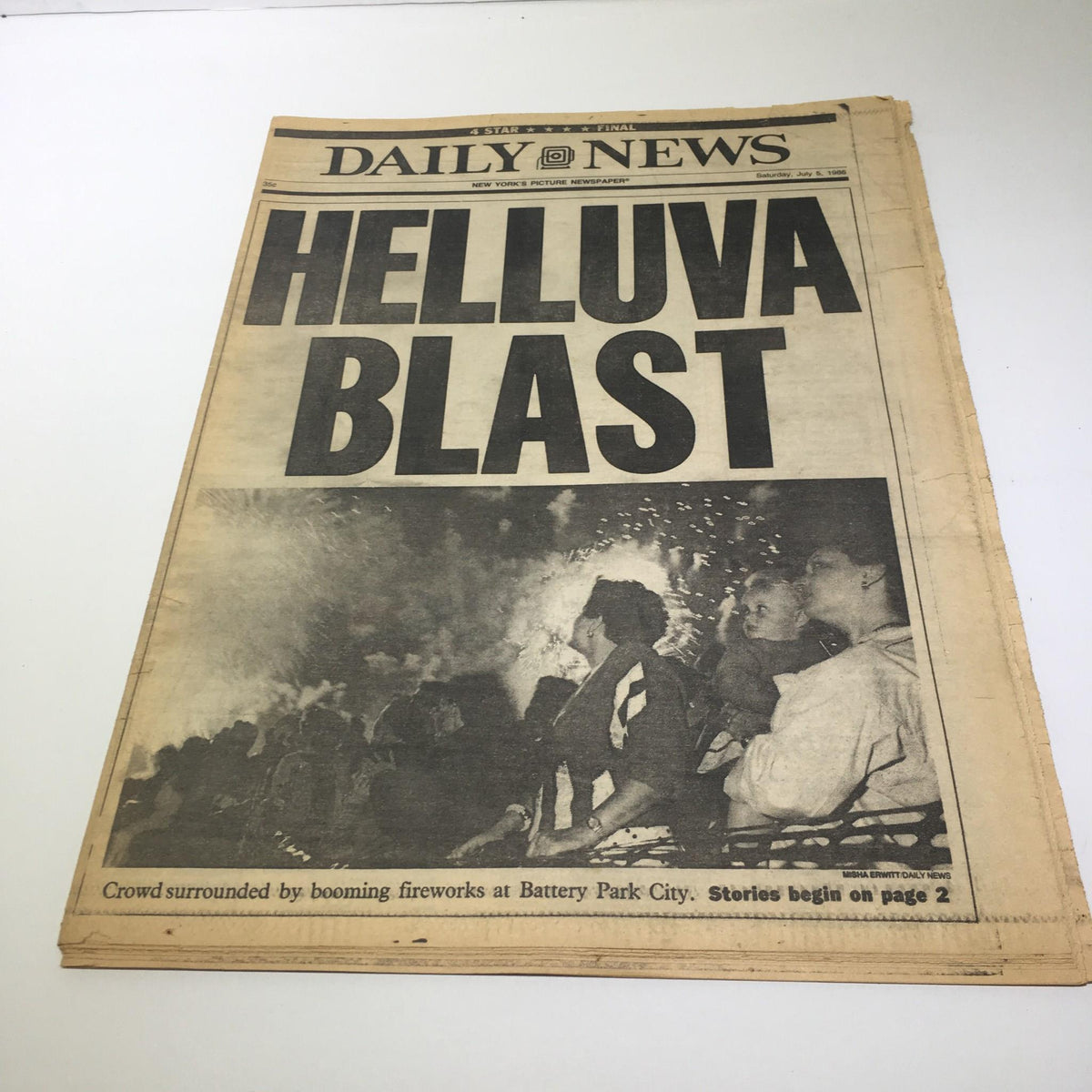New York Daily News, July 5, 1986, cover featuring the headline 'HELLUVA BLAST' with an image of a crowd surrounded by fireworks at Battery Park City, capturing the excitement of a summer evening.