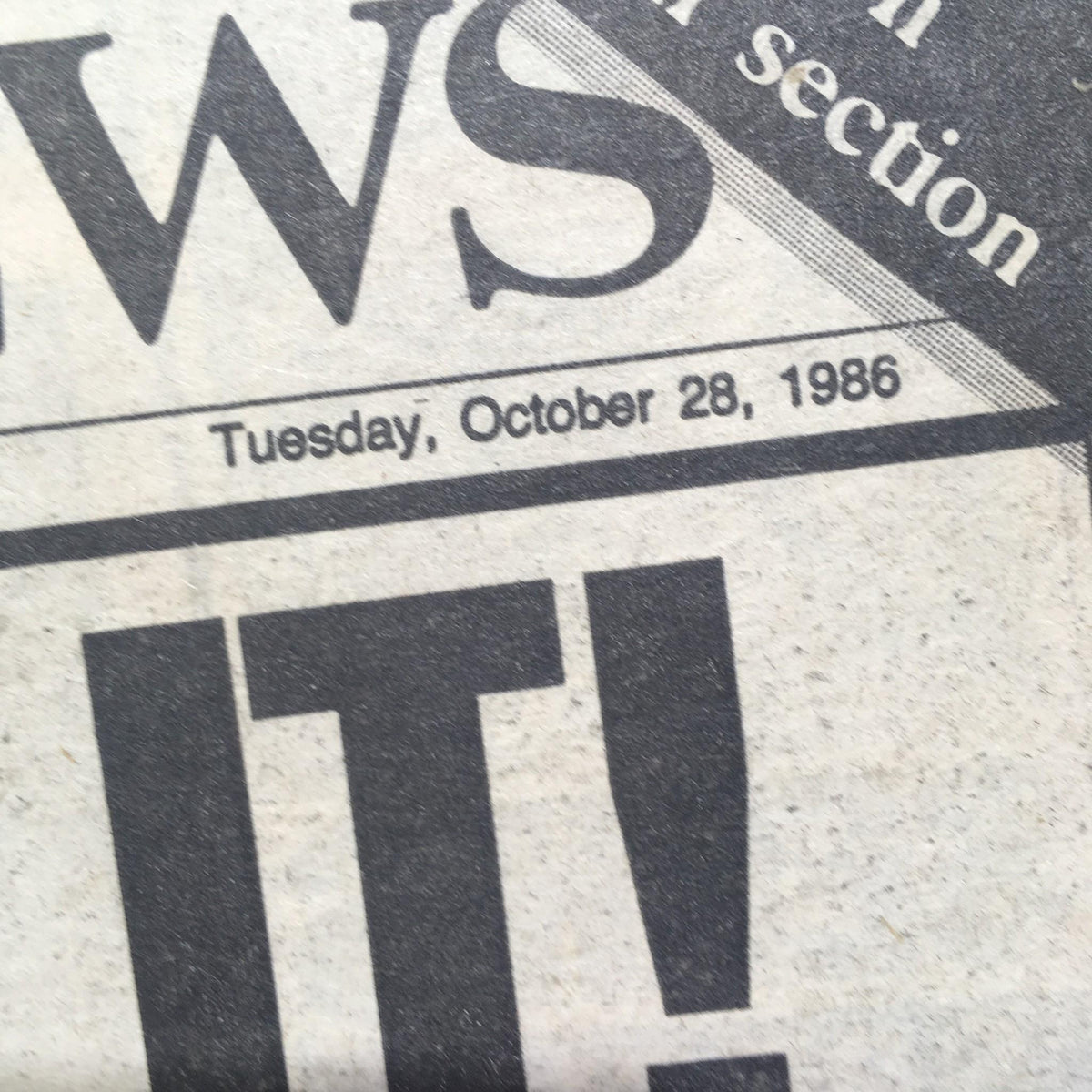 Close-up of the date on the NY Daily News from October 28, 1986, highlighting the significant day the Mets won the World Series against the Red Sox.