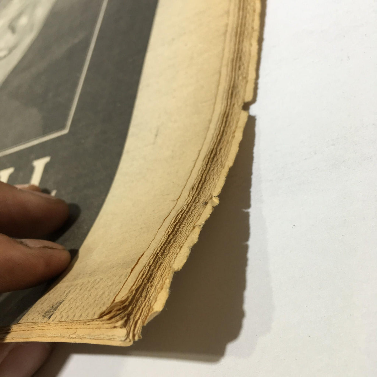 Close-up of the edge of the November 6, 1991 NY Daily News, showing worn pages for the tribute to Robert Maxwell, 1923-1991.