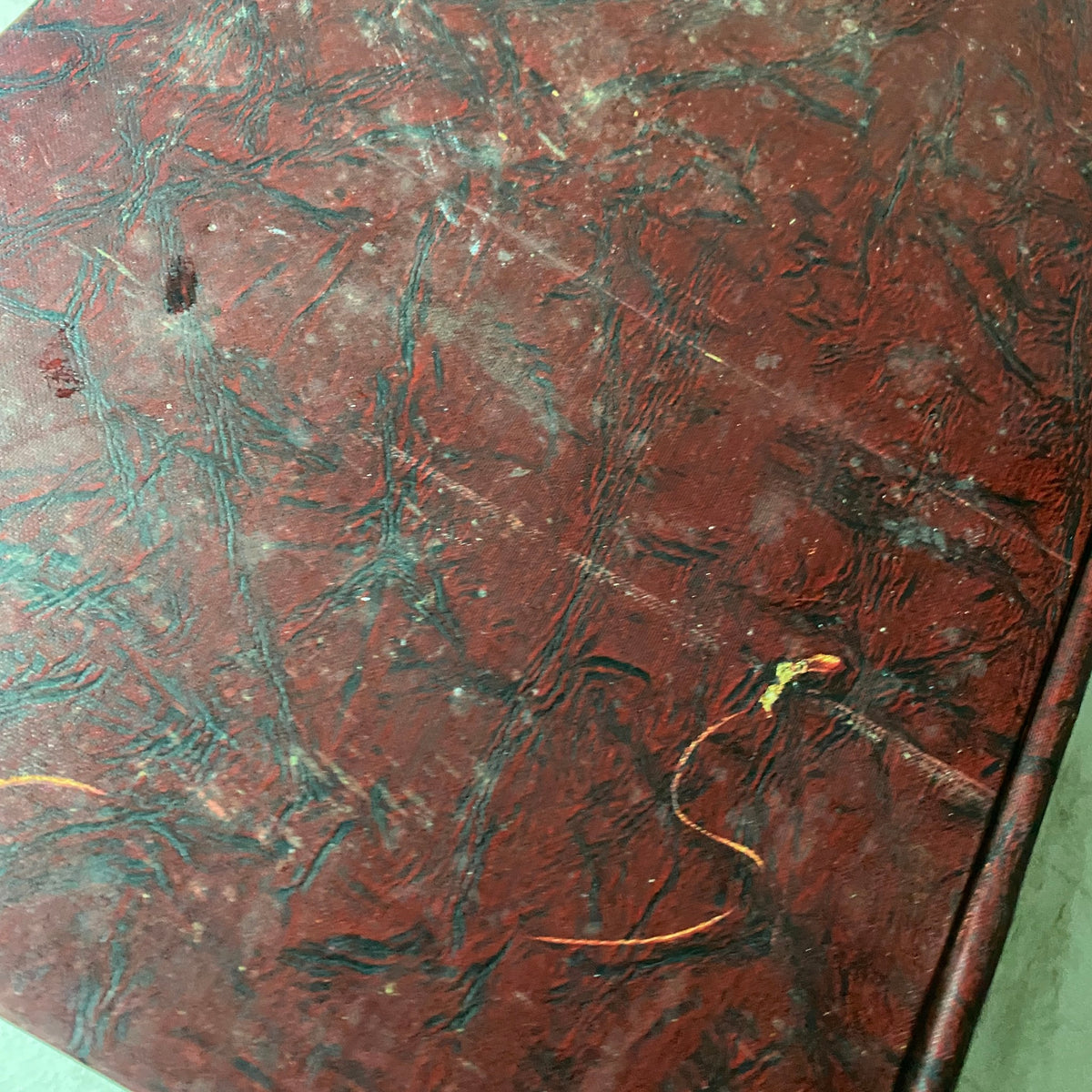 Close-up view of the textured surface of the red hardcover of VTG 1937 Bound Life Magazine, highlighting the wear and age of the book.