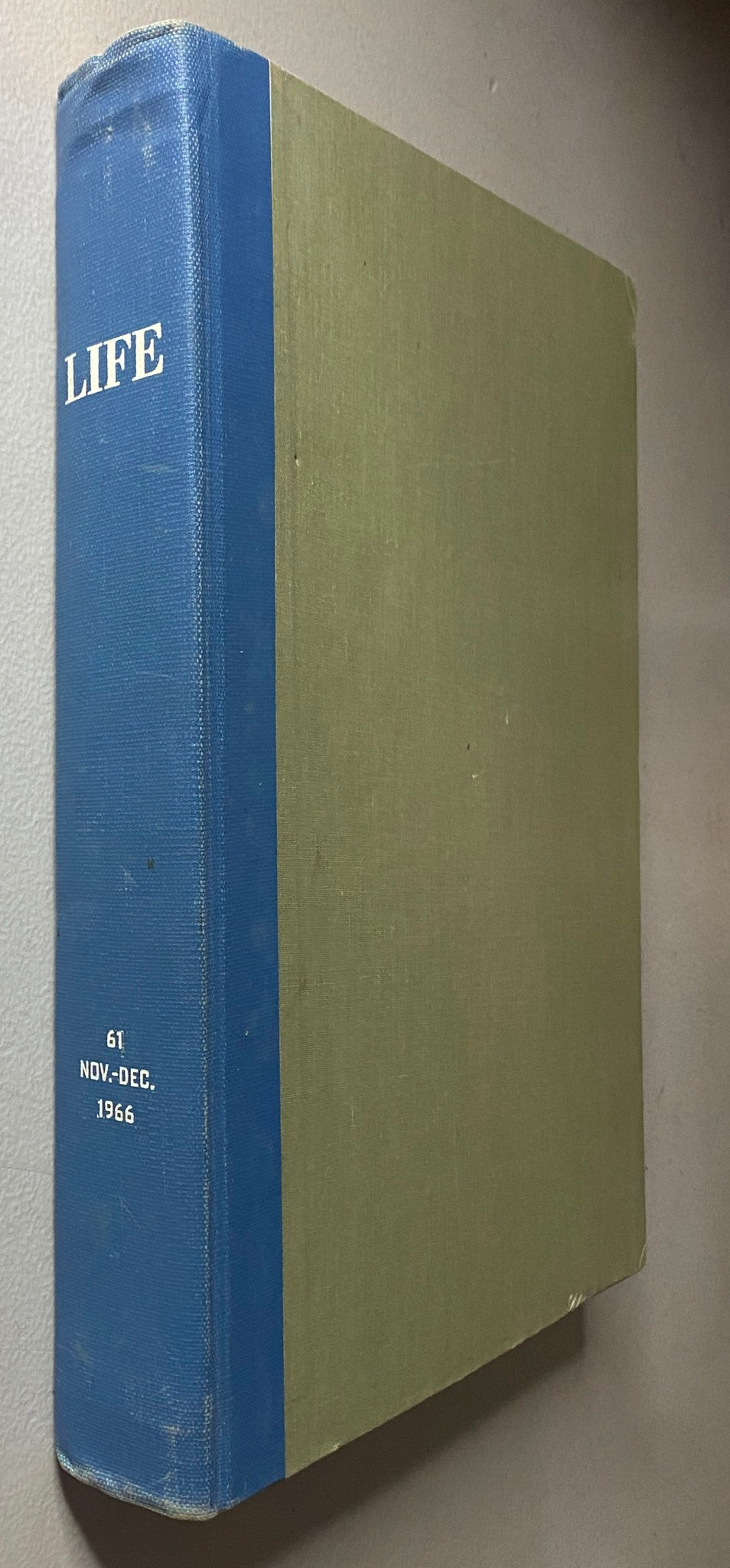 Side view of the VTG 1966 Bound Life Magazine November - December Weekly Issue with blue spine and green cover.