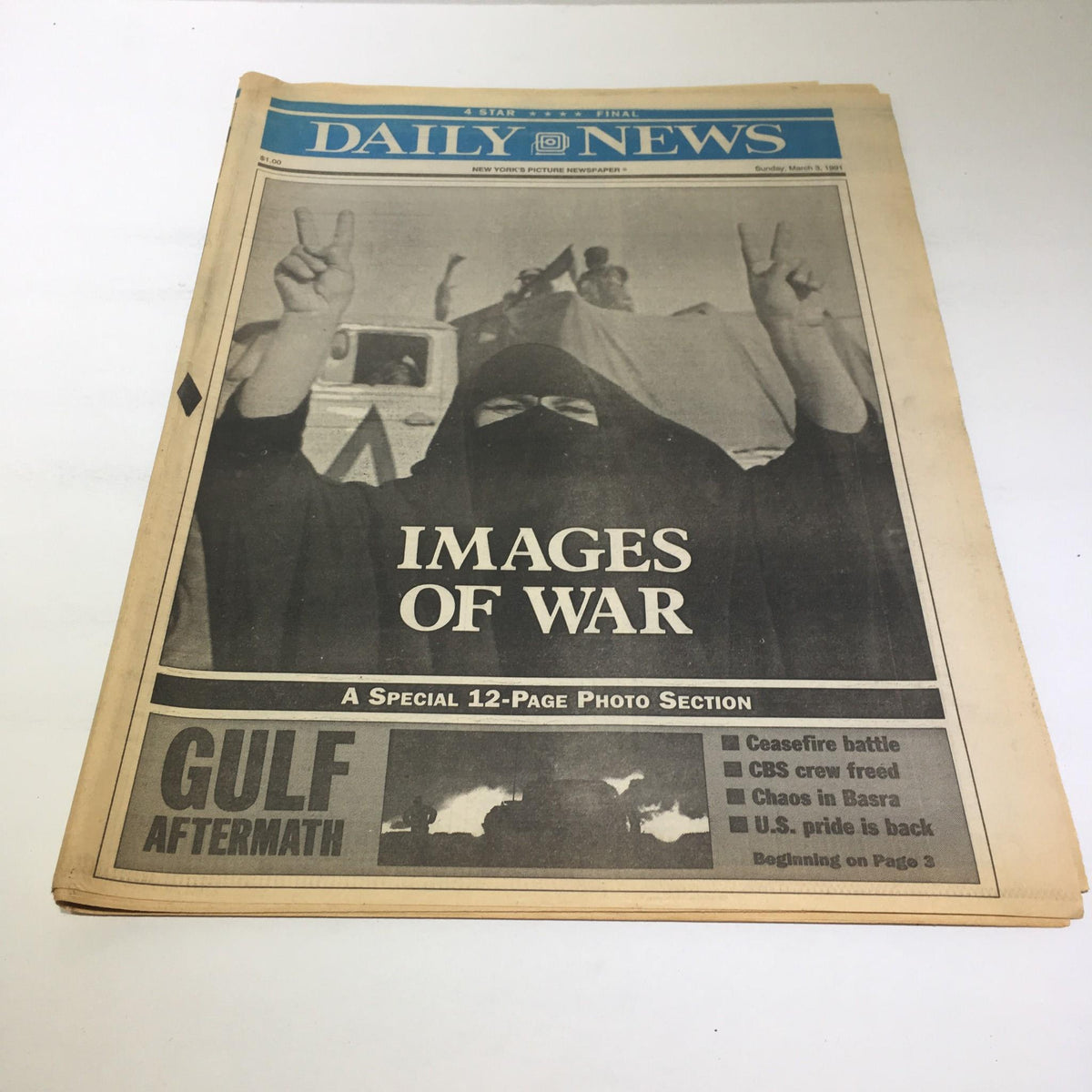 NY Daily News: March 3 1991, Images Of War featuring a cover photo with a person in a black hijab raising two fingers in a peace sign, highlighting themes of conflict and resolution in the Gulf aftermath.