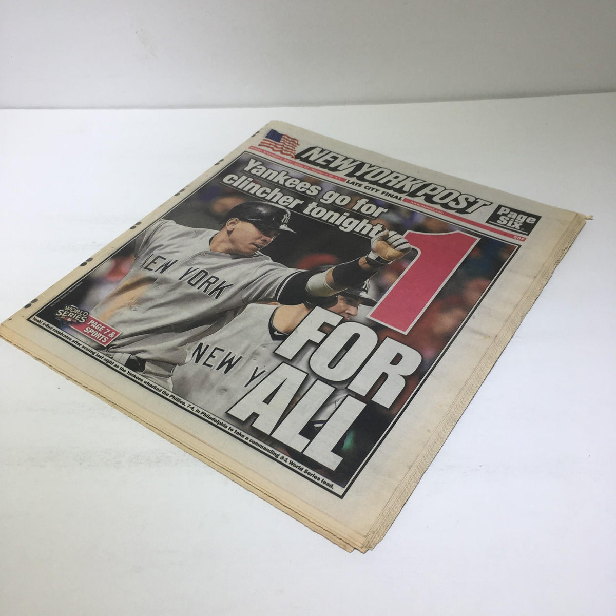 Another view of the New York Post featuring the headline 'Yankees Go for Clincher Tonight, 1 For All', displaying team camaraderie during the 2009 World Series.