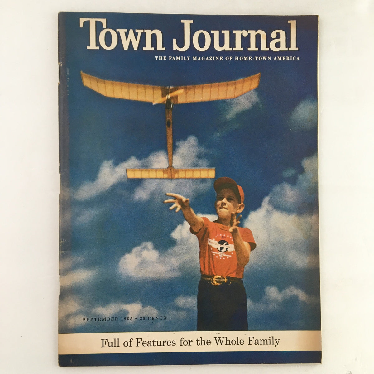 Cover of Town Journal Magazine September 1955 featuring a boy with a toy airplane, highlighting family-friendly content.