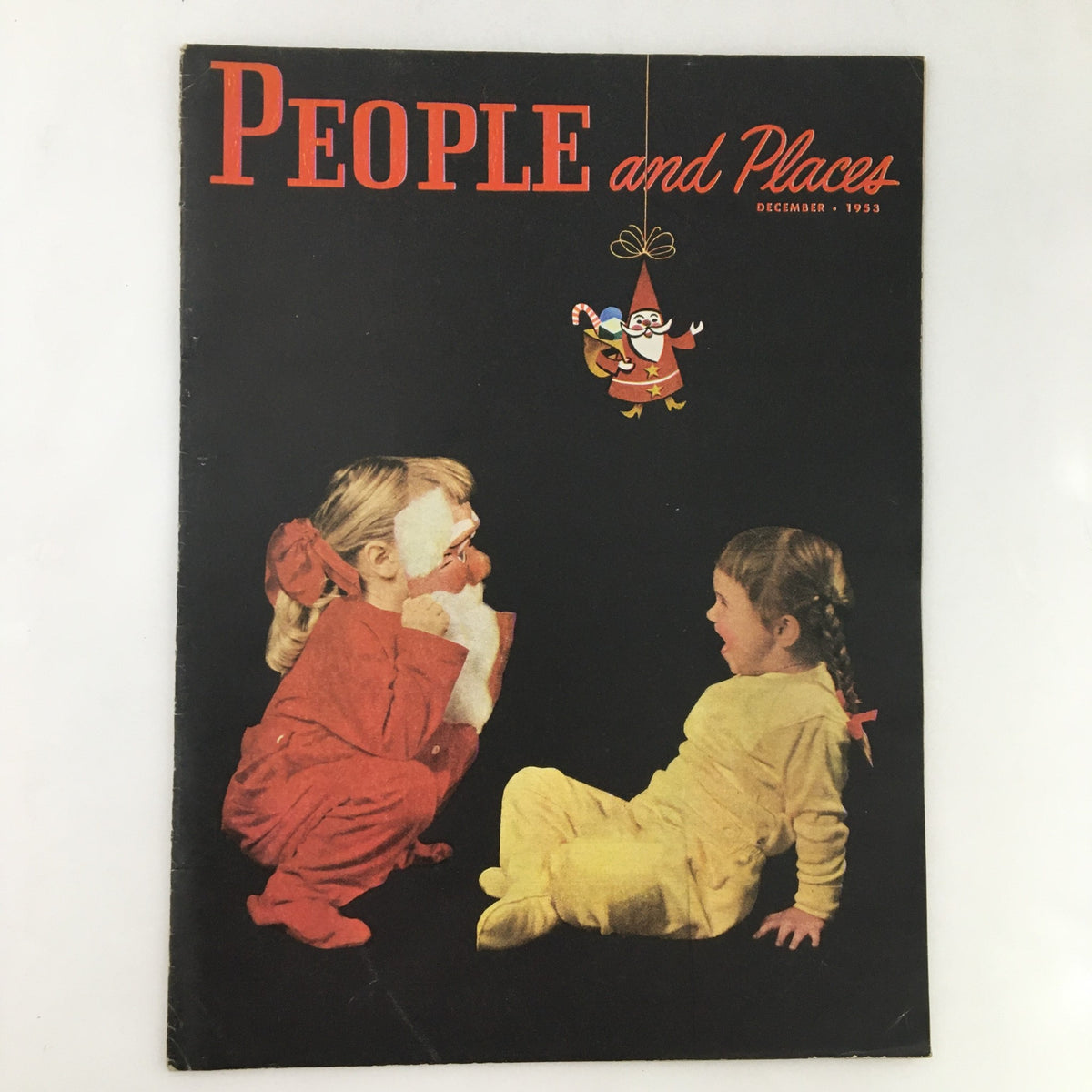 Cover of People and Places Magazine December 1953 featuring children playing, showcasing vintage design and seasonal theme.