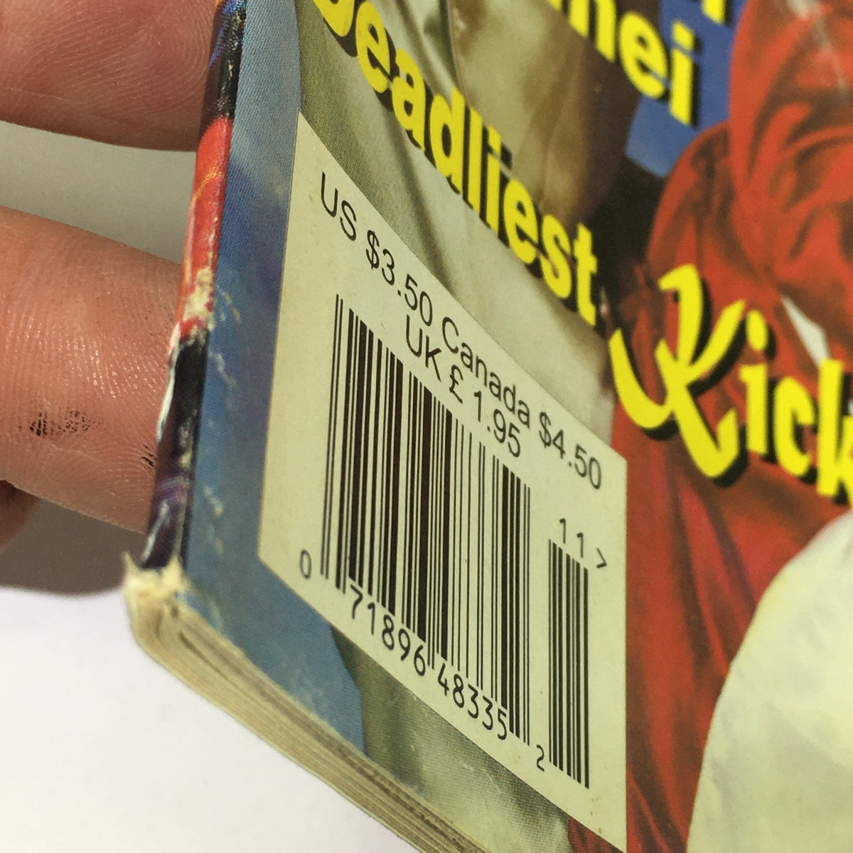Close-up view of the spine of the Wushu Qidong Kung Fu Magazine, October November 1996 issue, displaying the barcode and price details, highlighting its collectible nature.