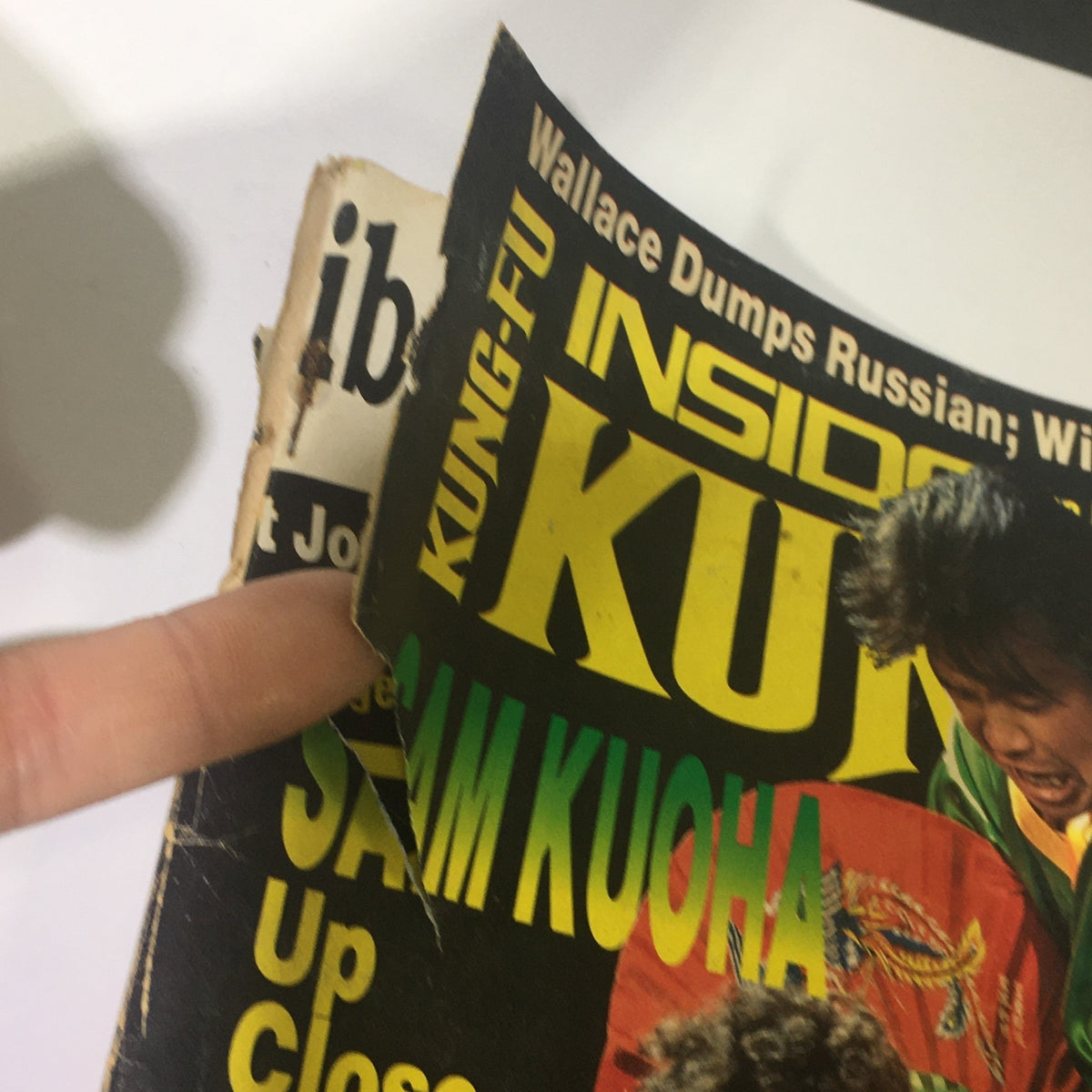 Close-up of the spine of Inside Kung Fu Magazine September 1990, highlighting wear and tear along the edges, an indicator of its vintage condition.