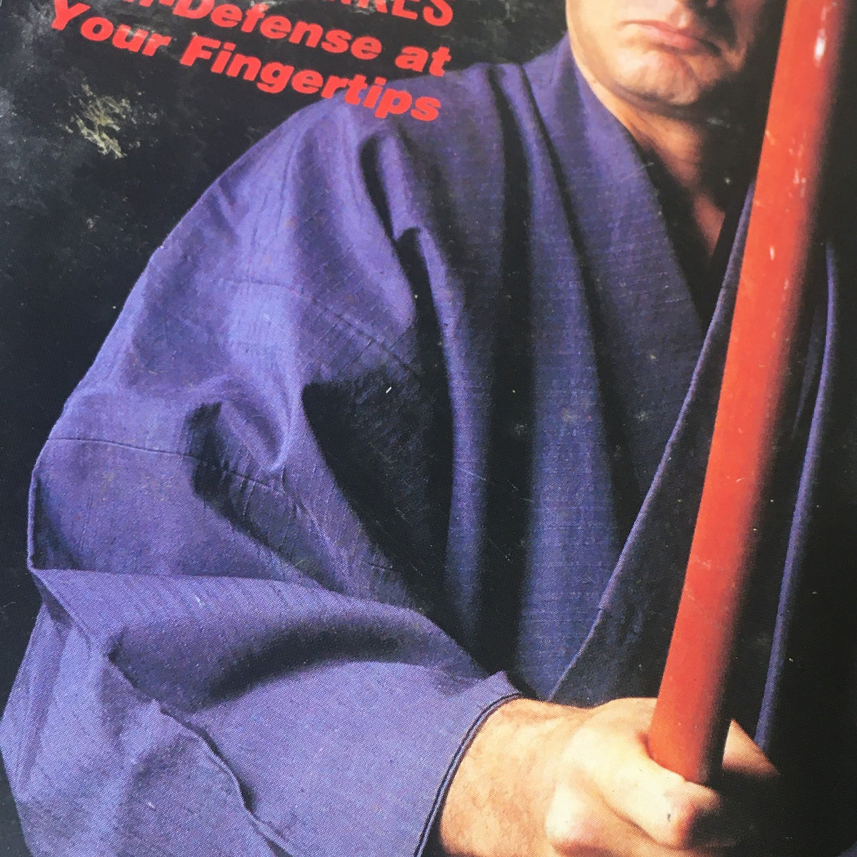 Detailed view of the cover of Black Belt Magazine December 1990, showcasing martial arts self-defense topics and the portrayal of Dan Inosanto.