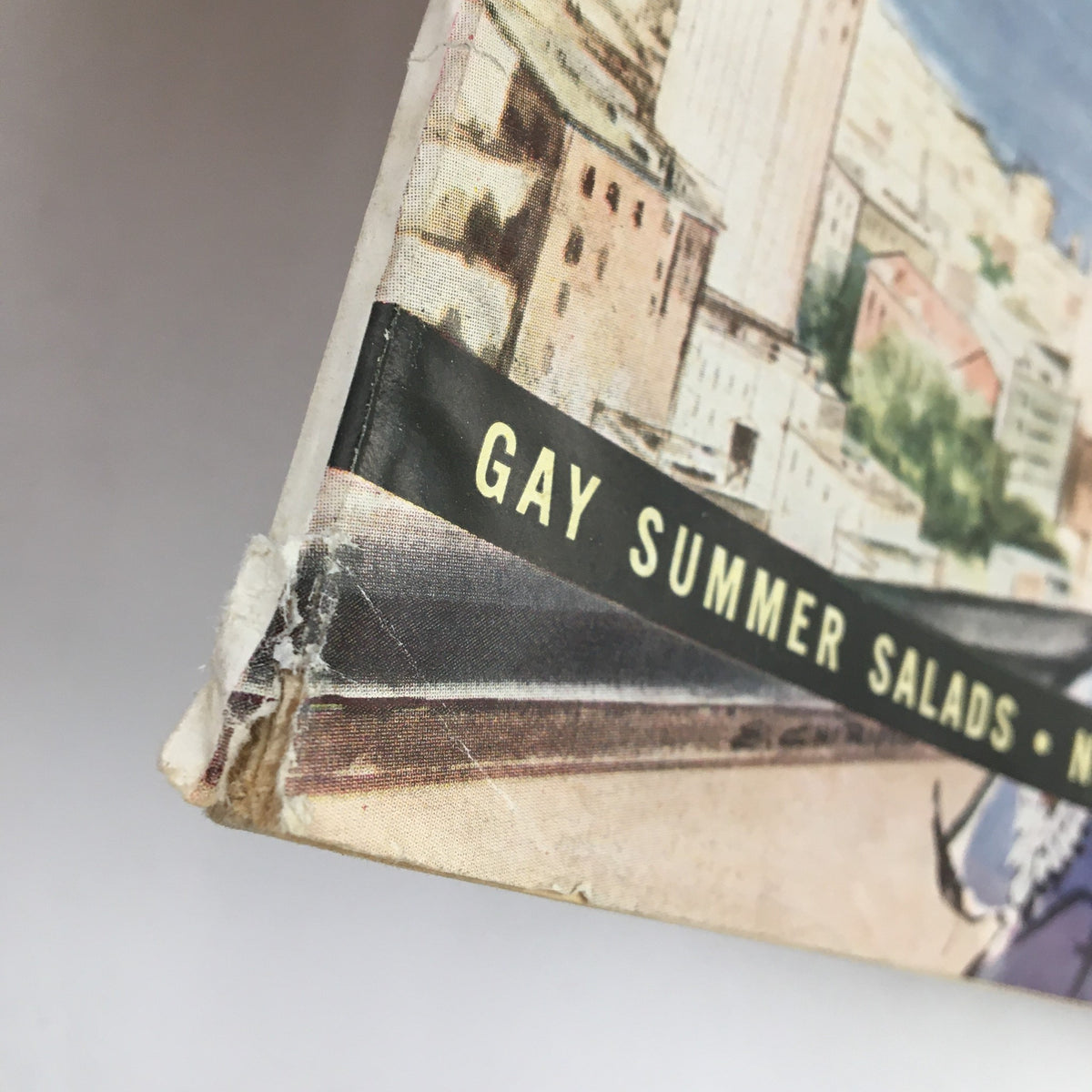 Close-up view of the worn edge of Family Circle Magazine August 1958, highlighting the feature 'Gay Summer Salads' on the spine.