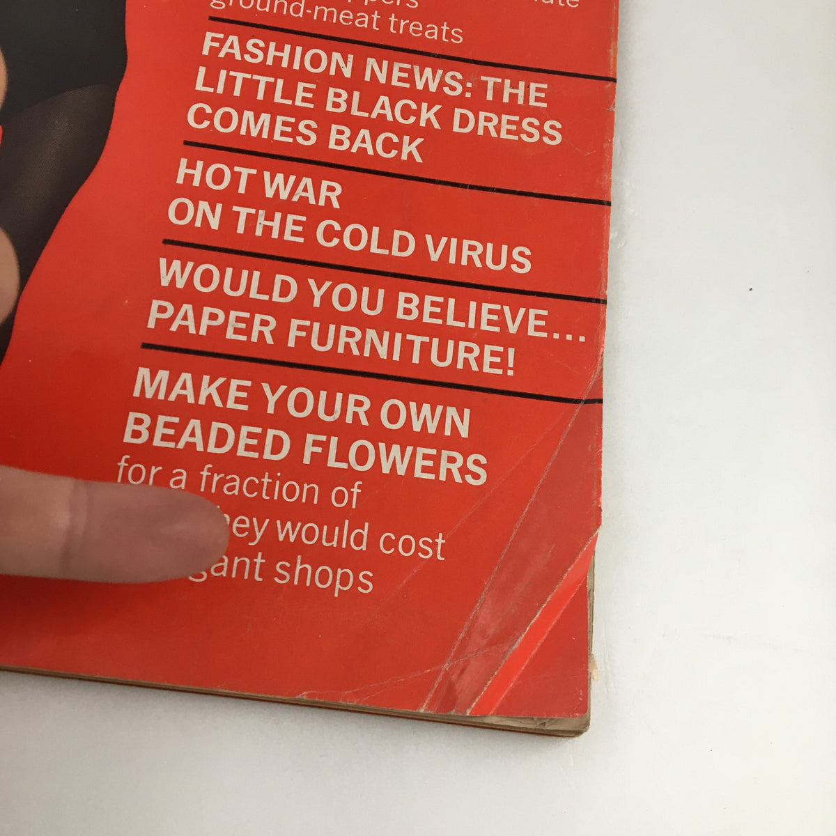 Detail view of Family Circle Magazine October 1967 cover, emphasizing the text on the magazine including 'Fashion News: The Little Black Dress Comes Back'.