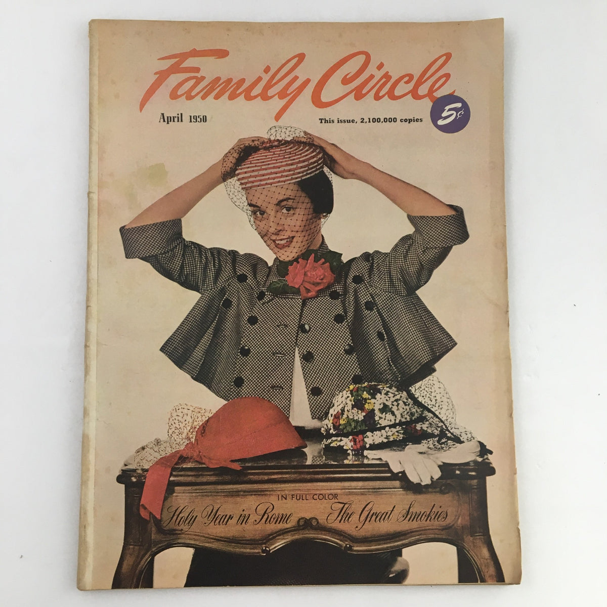 Cover of Family Circle Magazine, April 1950 edition, featuring a woman wearing a stylish hat and a polka-dotted coat, showcasing themes of 'Holy Year in Rome & The Great Smokies'.