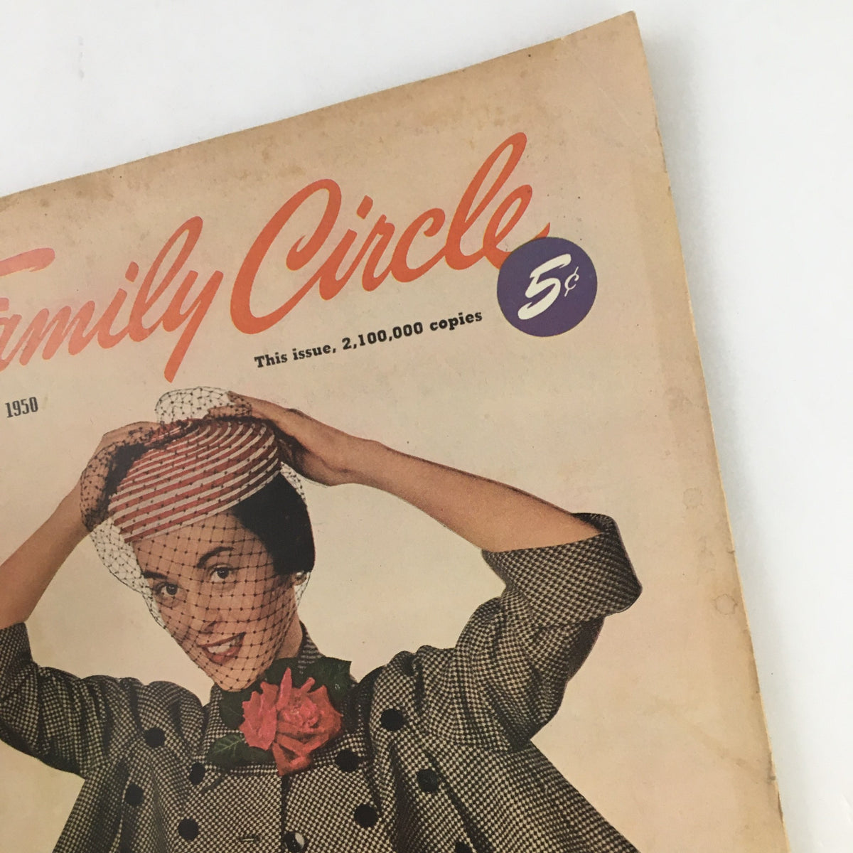 Cover of Family Circle Magazine from April 1950 featuring a woman in vintage fashion holding a hat with a netted veil and a rose, highlighting the themes of the Holy Year in Rome and the Great Smokies.