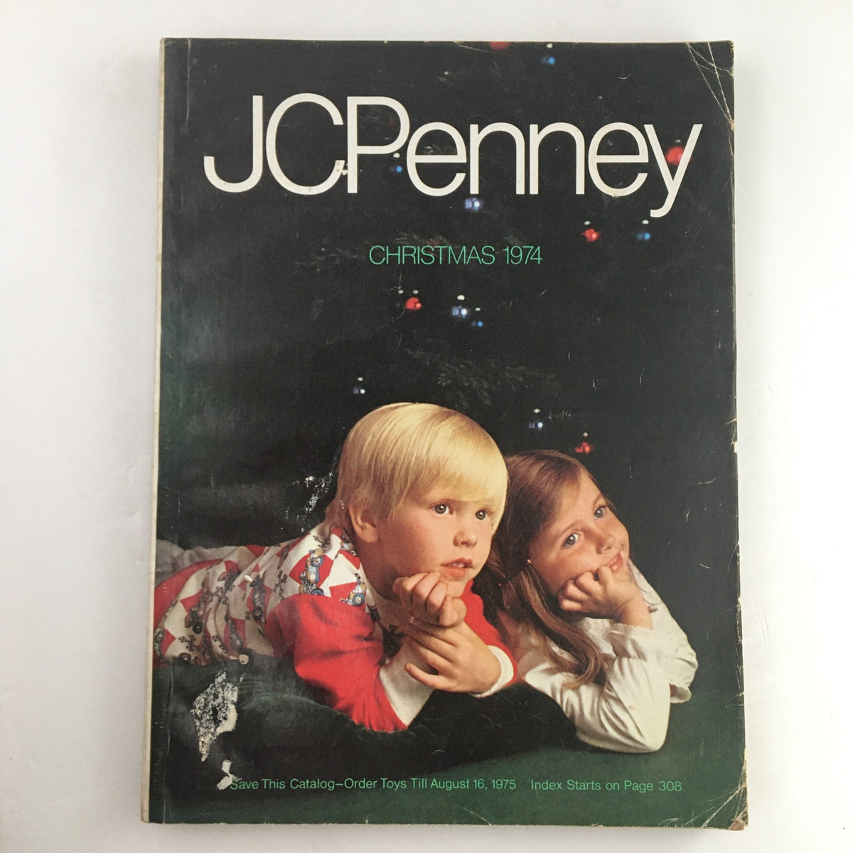 1974 JCPenney Christmas Colorful Weebles Toys and Dresses Price Catalog cover featuring two children in festive clothing, displaying a playful and nostalgic holiday theme.