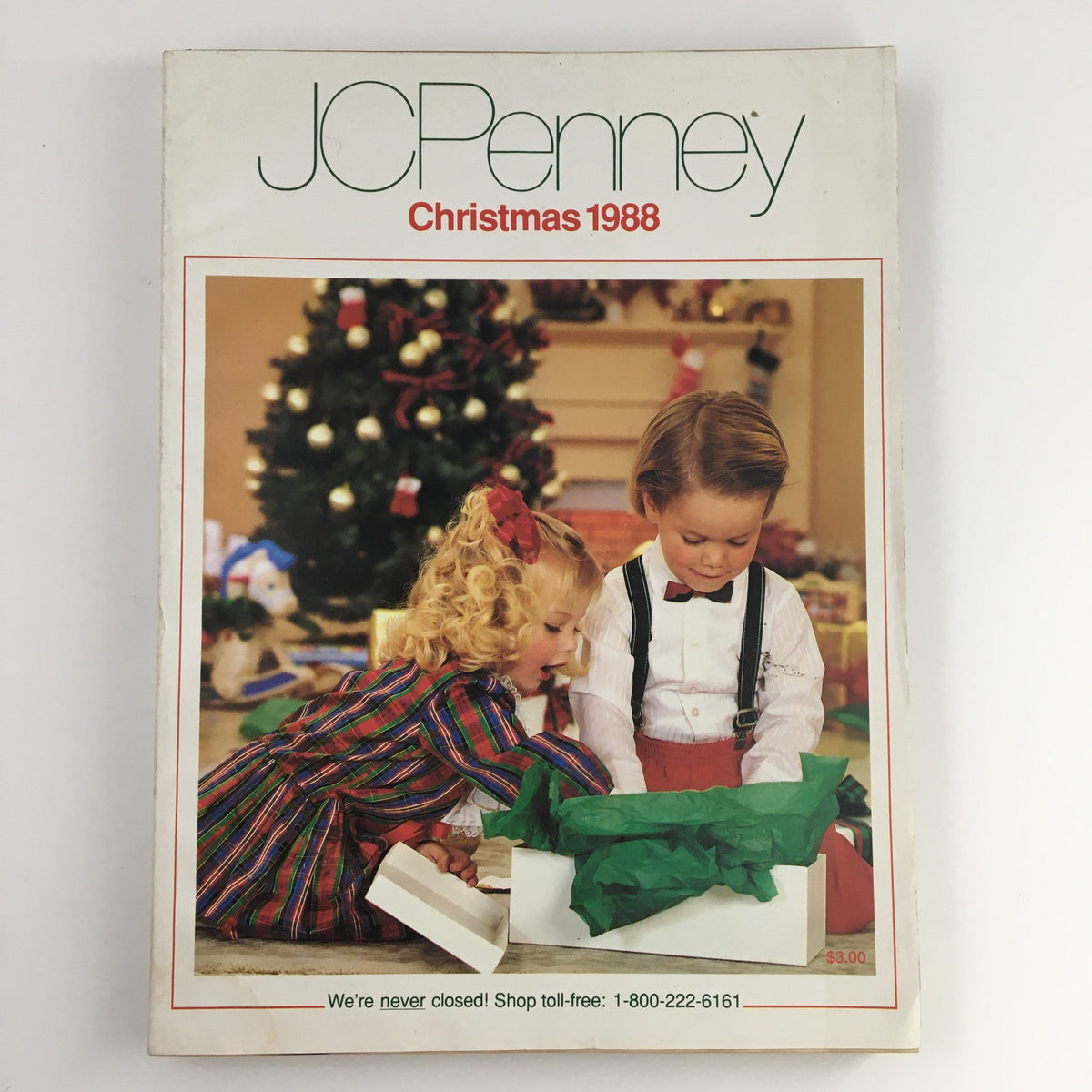 Cover of 1988 The JCPenney Dandy Dress-ups and Pinafore Pretties Catalog showcasing children playing with holiday gifts, set against a Christmas tree backdrop.