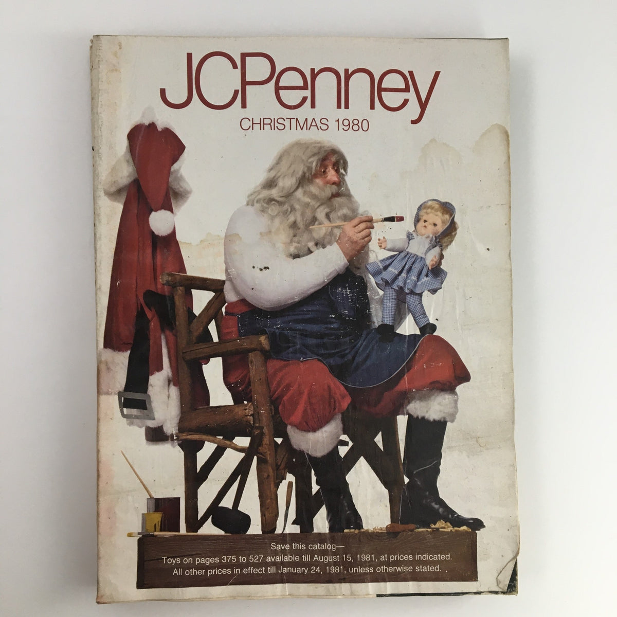 1980 The JCPenney Dandy Christmas A World of Fashion Catalog cover featuring Santa Claus sitting on a chair, holding a doll, with the text 'JCPenney Christmas 1980' clearly visible.