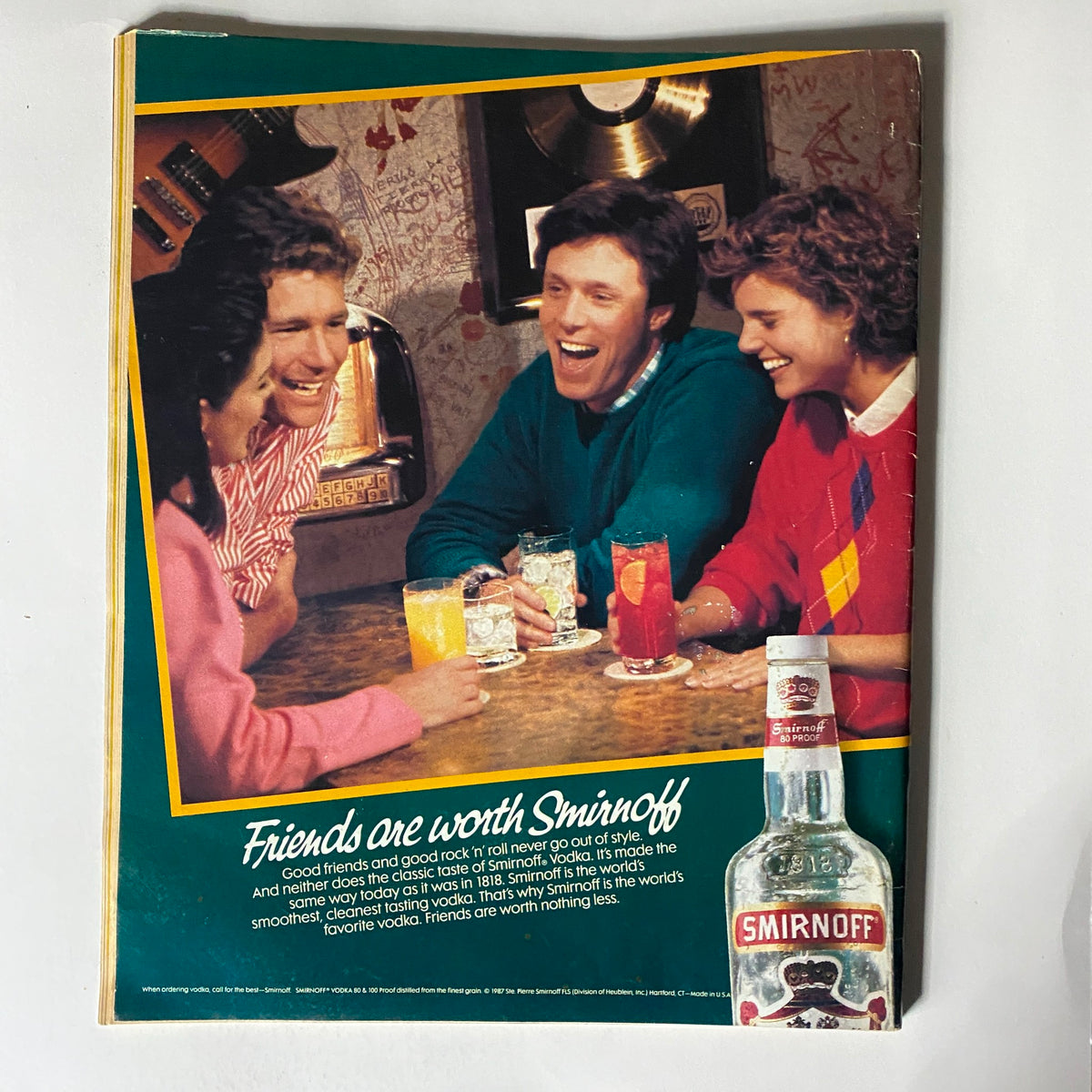 Back cover of the VTG Spin Magazine January 1988 displaying a Smirnoff vodka advertisement with a group of friends at a bar.