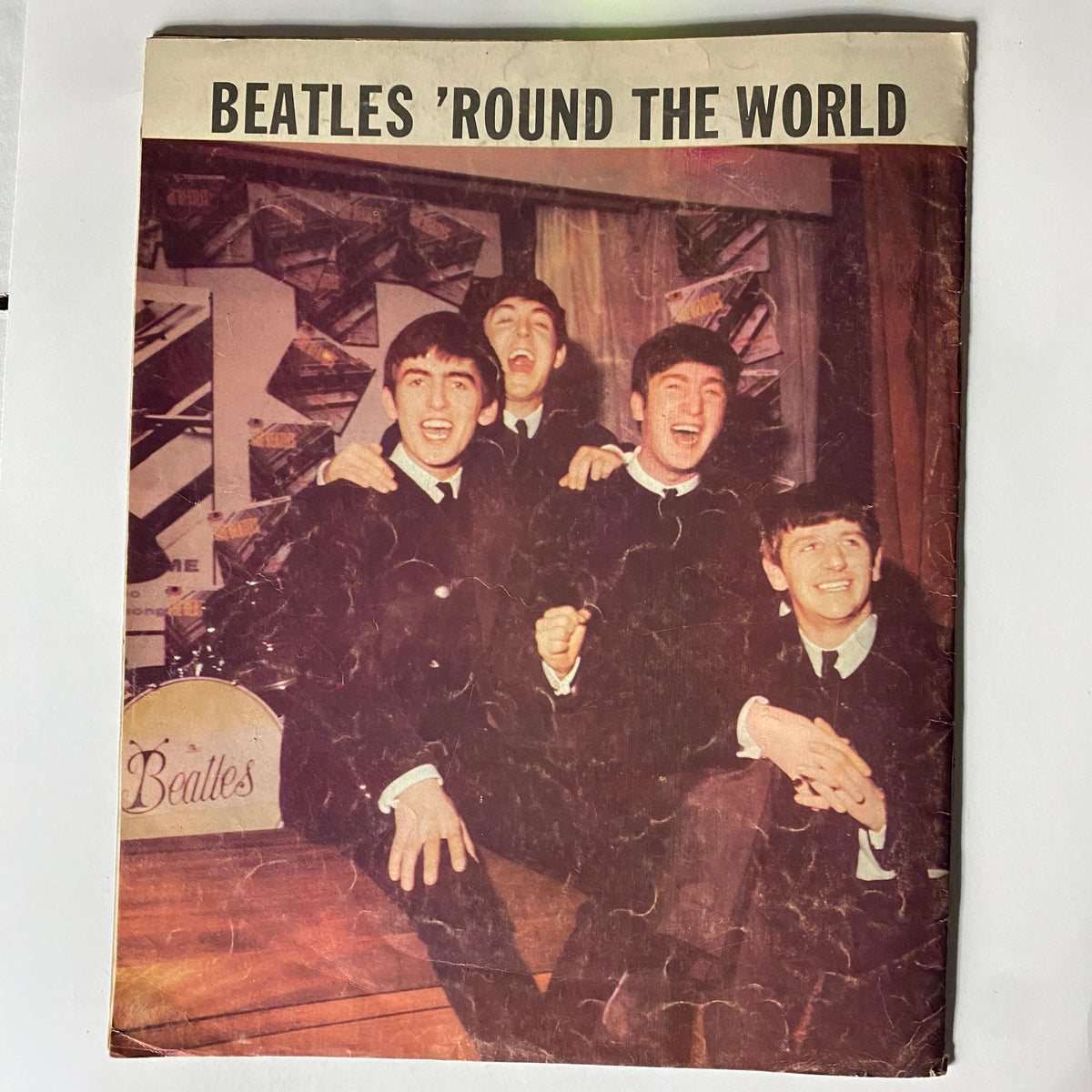 Back cover of the Vintage 1964 The Beatles Around The World Magazine depicting The Beatles joyfully posing together, symbolizing their legendary status in music history.