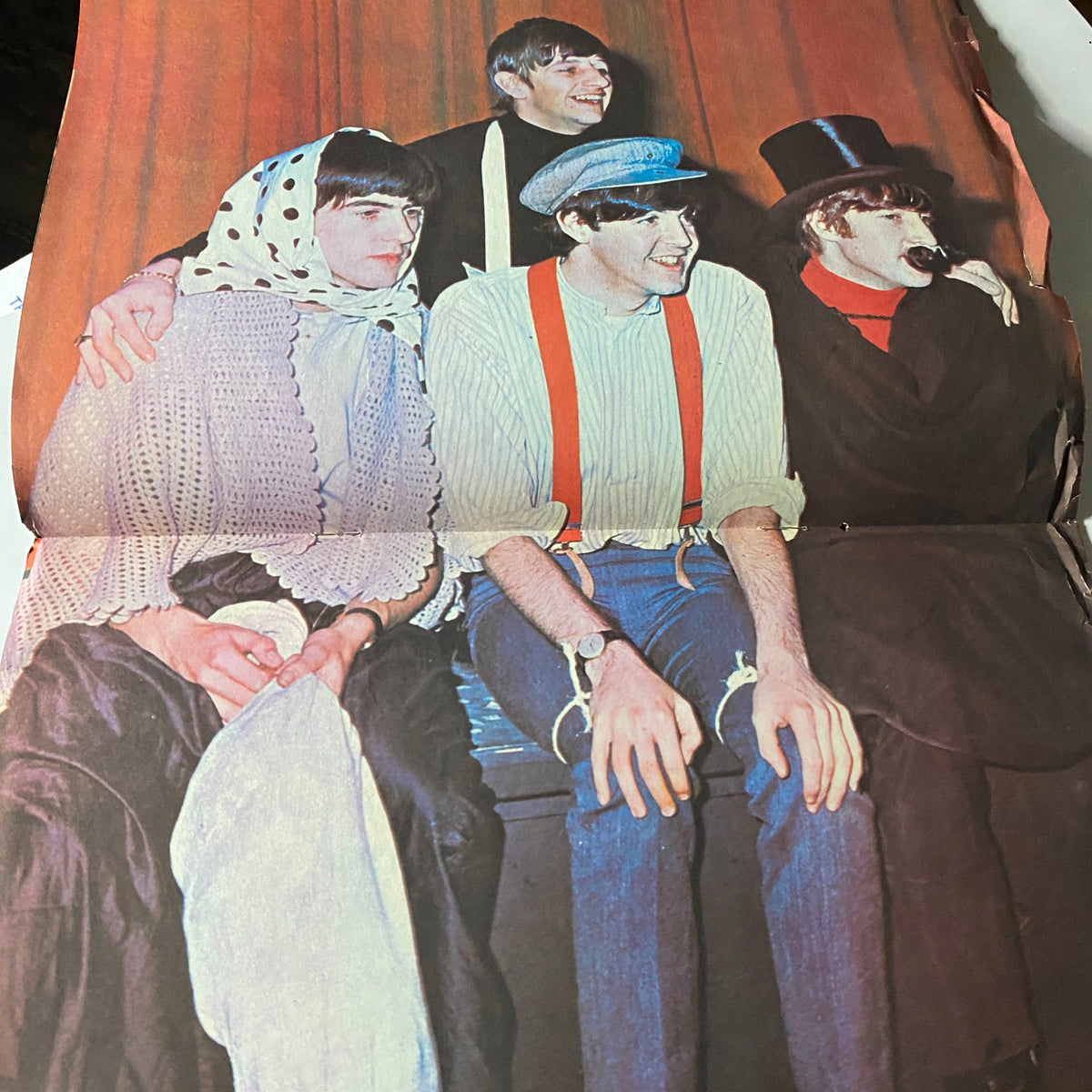 Colorful image from a 1964 vintage magazine of The Beatles in playful costumes, highlighting their fun and charismatic personalities, part of the Beatlemania collectors item.
