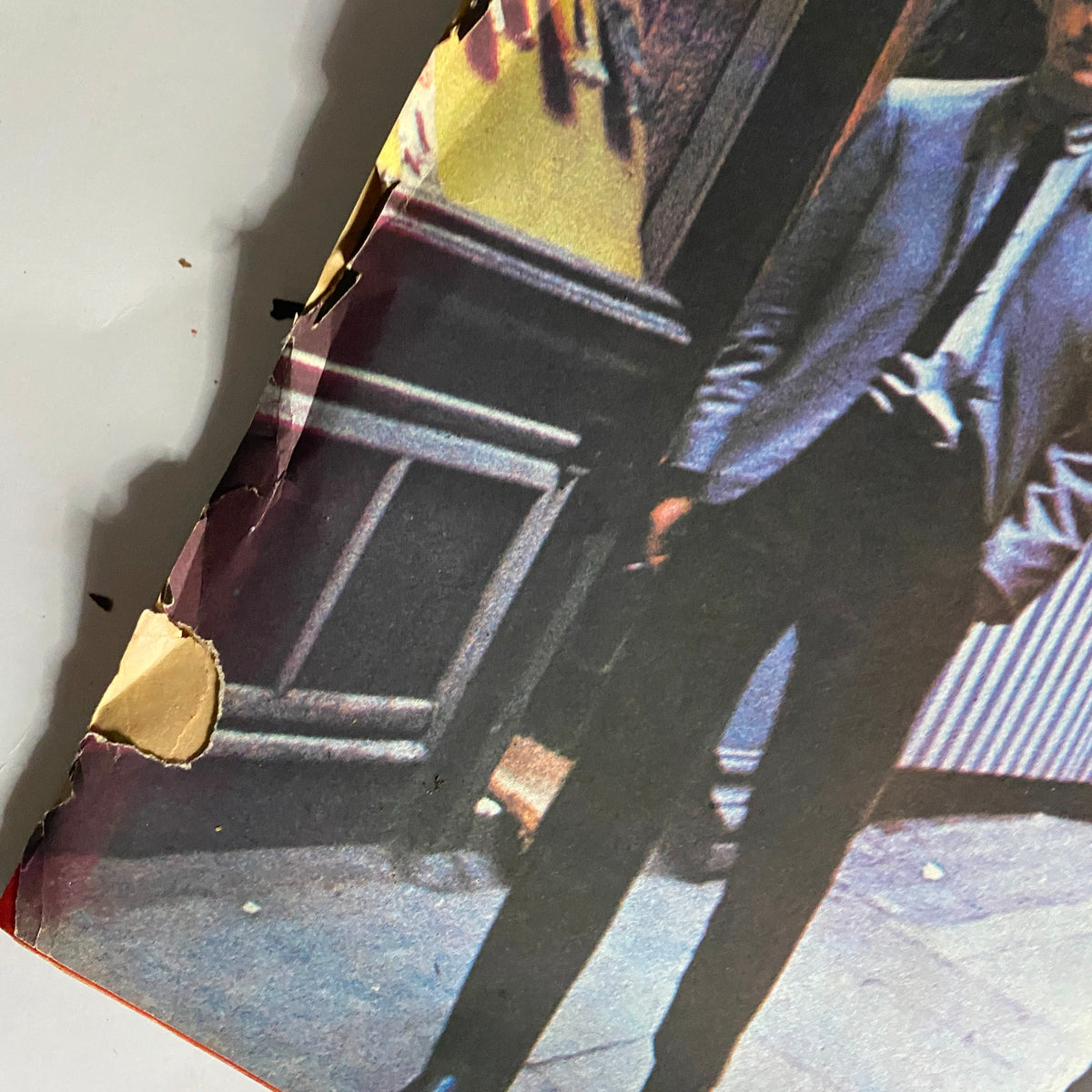 Damage details on the cover of a 1964 vintage magazine featuring The Beatles, highlighting the historical significance and character of this collectible item celebrating Beatlemania.