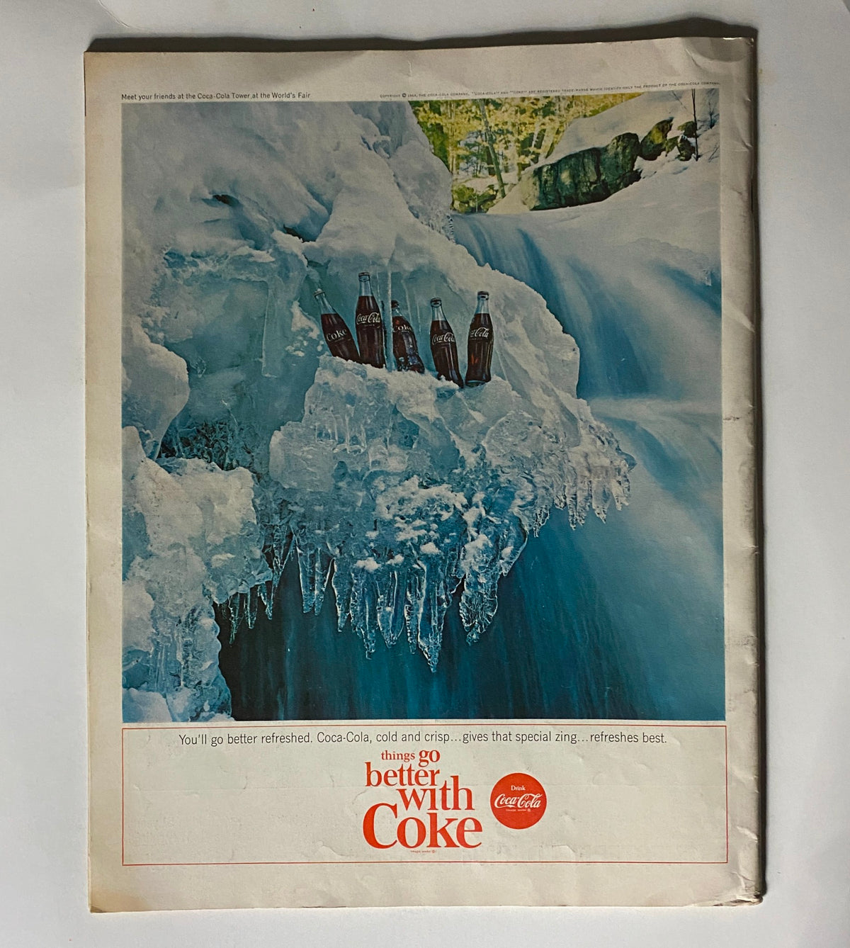 Vintage advertisement showcasing Coca-Cola bottles surrounded by ice in a winter landscape. Featured in the VTG Saturday Evening Post Magazine August 8 1964 The Beatles.