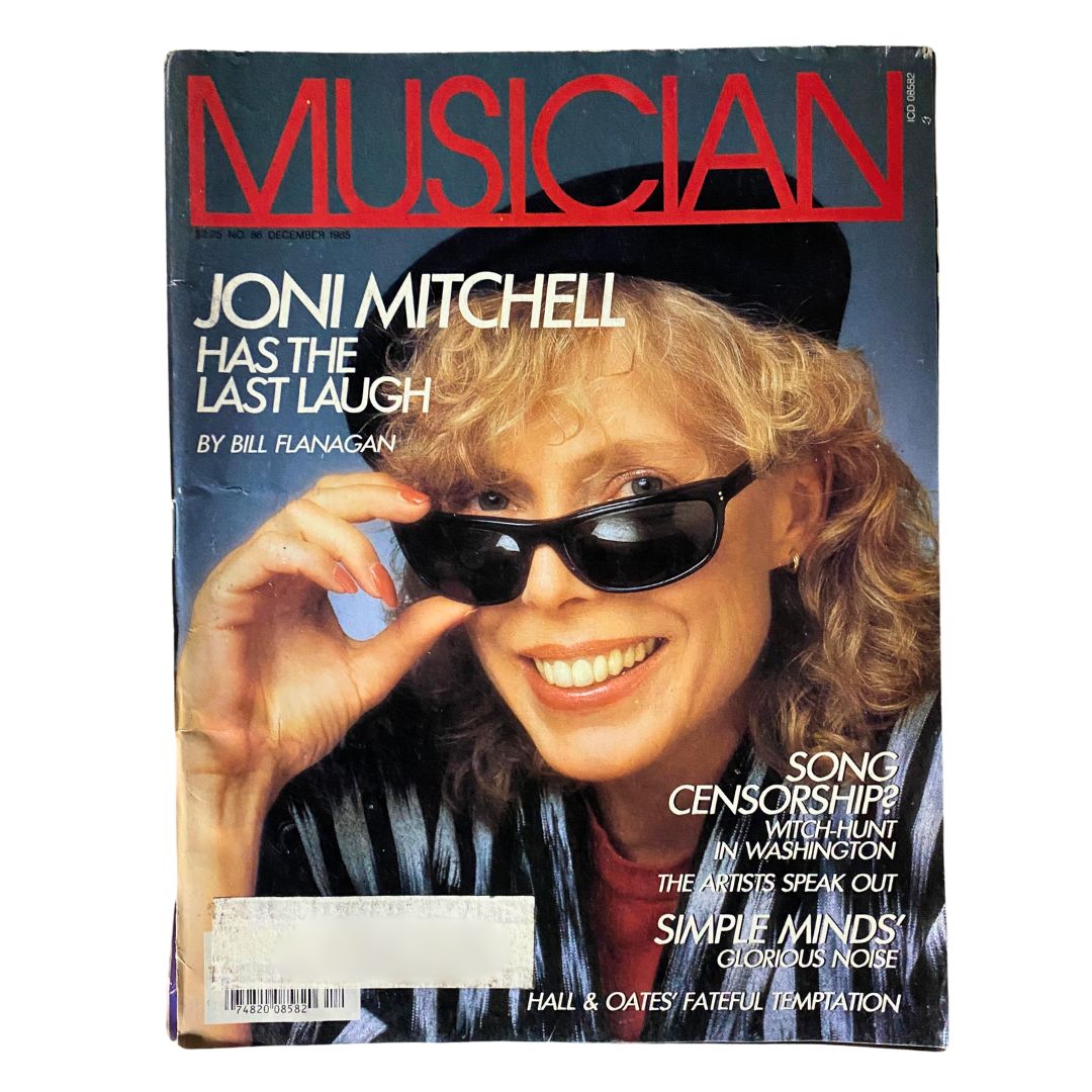 Cover of the VTG Musician Magazine December 1985 featuring Joni Mitchell with the headline 'Joni Mitchell Has The Last Laugh' by Bill Flanagan, showcasing her iconic style with sunglasses.