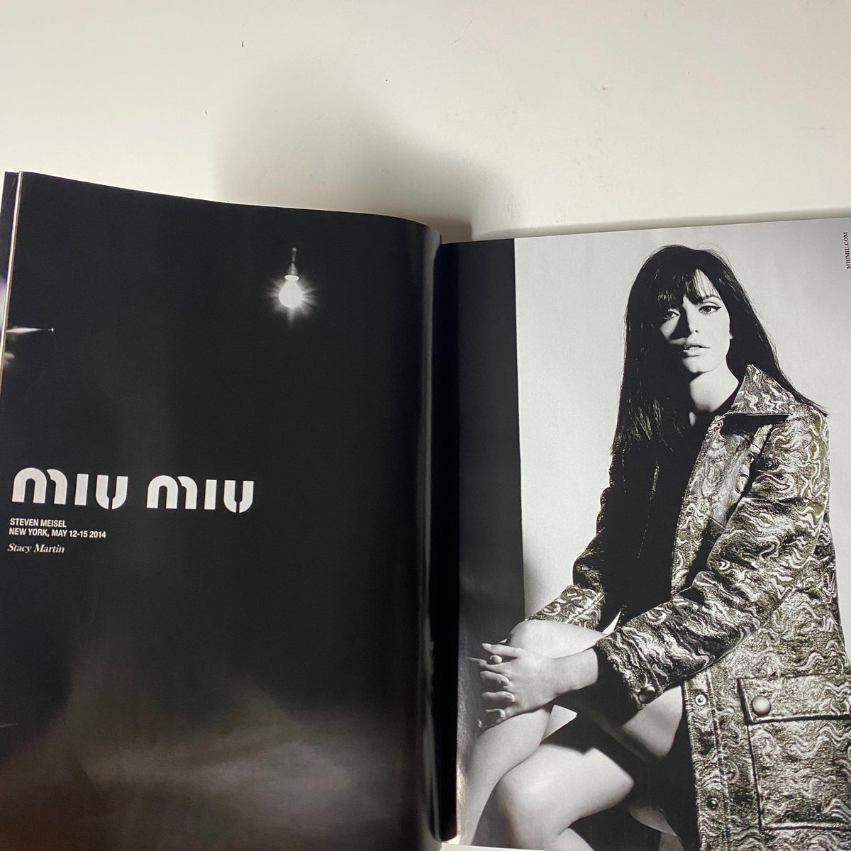 Vogue Magazine October 2014 showcasing a Miu Miu fashion spread with a model in black and white photography.