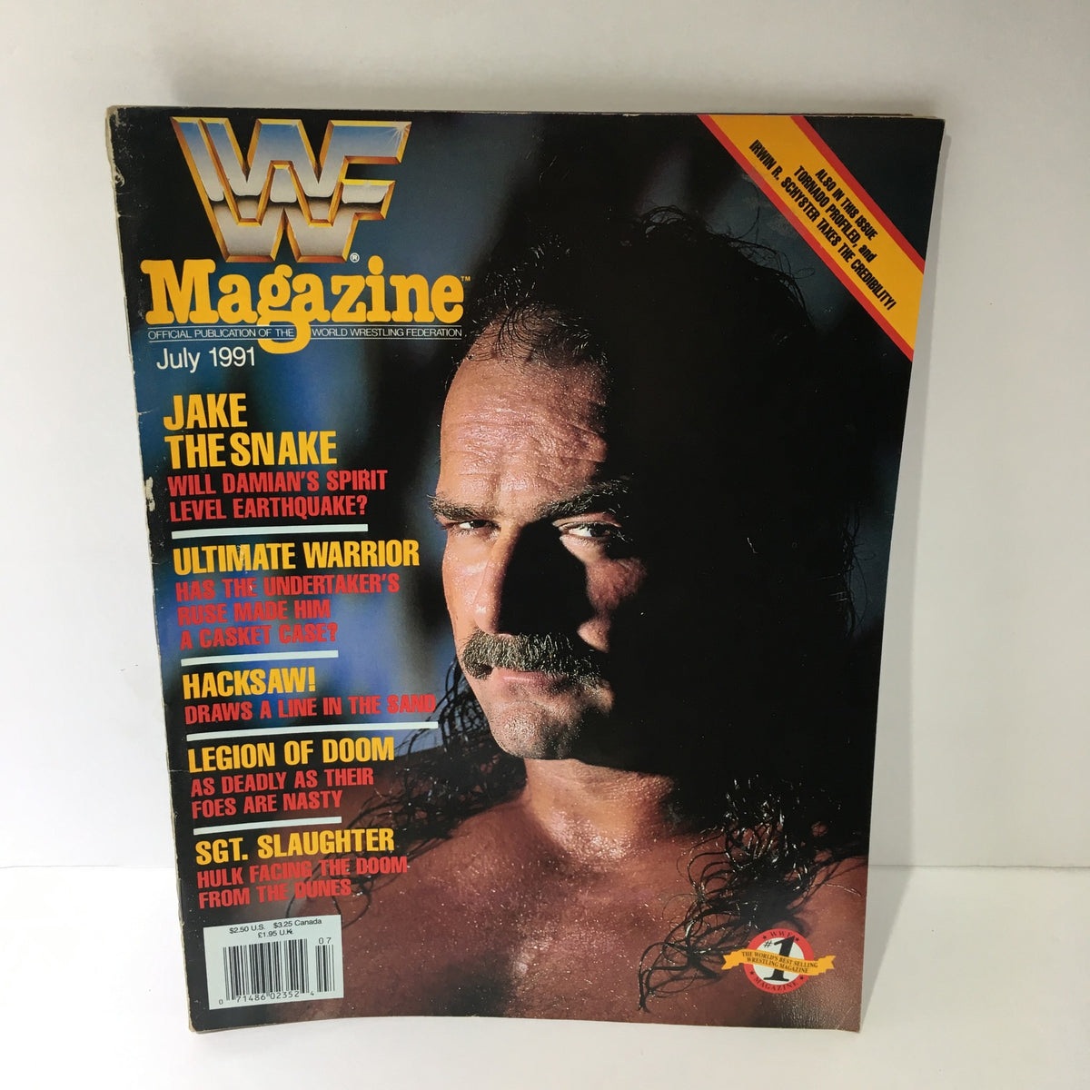 WWF Magazine featuring Jake the Snake on the cover, July 1991 issue with headlines about Damian's spirit, Ultimate Warrior, and Hacksaw.