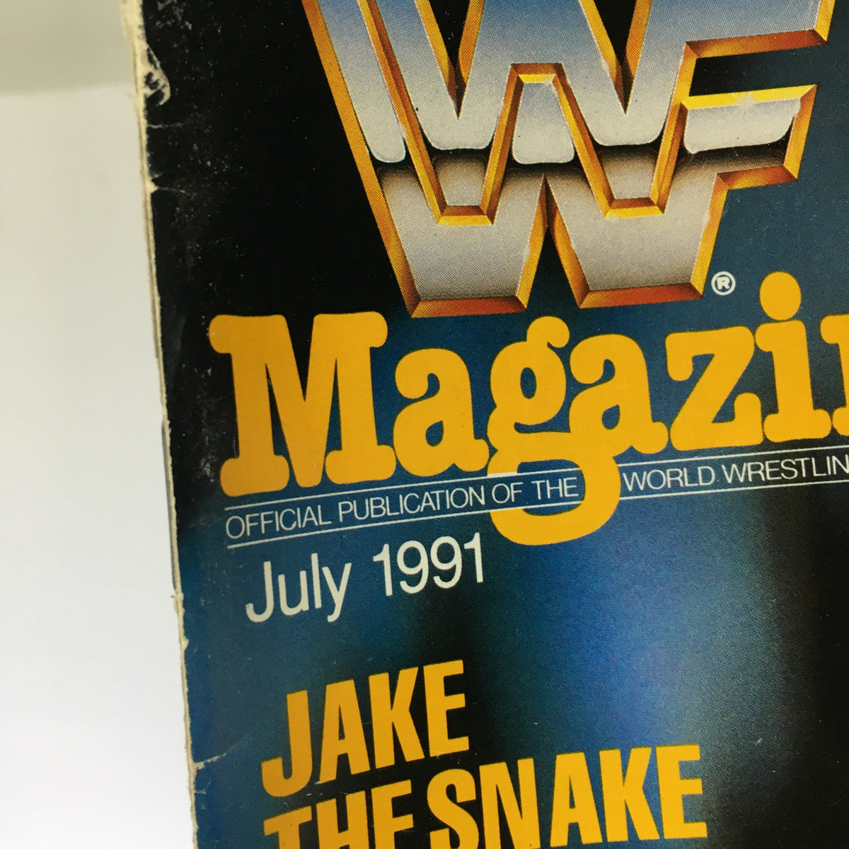 Close-up of the WWF Magazine title with Jake the Snake featured, July 1991 issue, showcasing the publication's branding.
