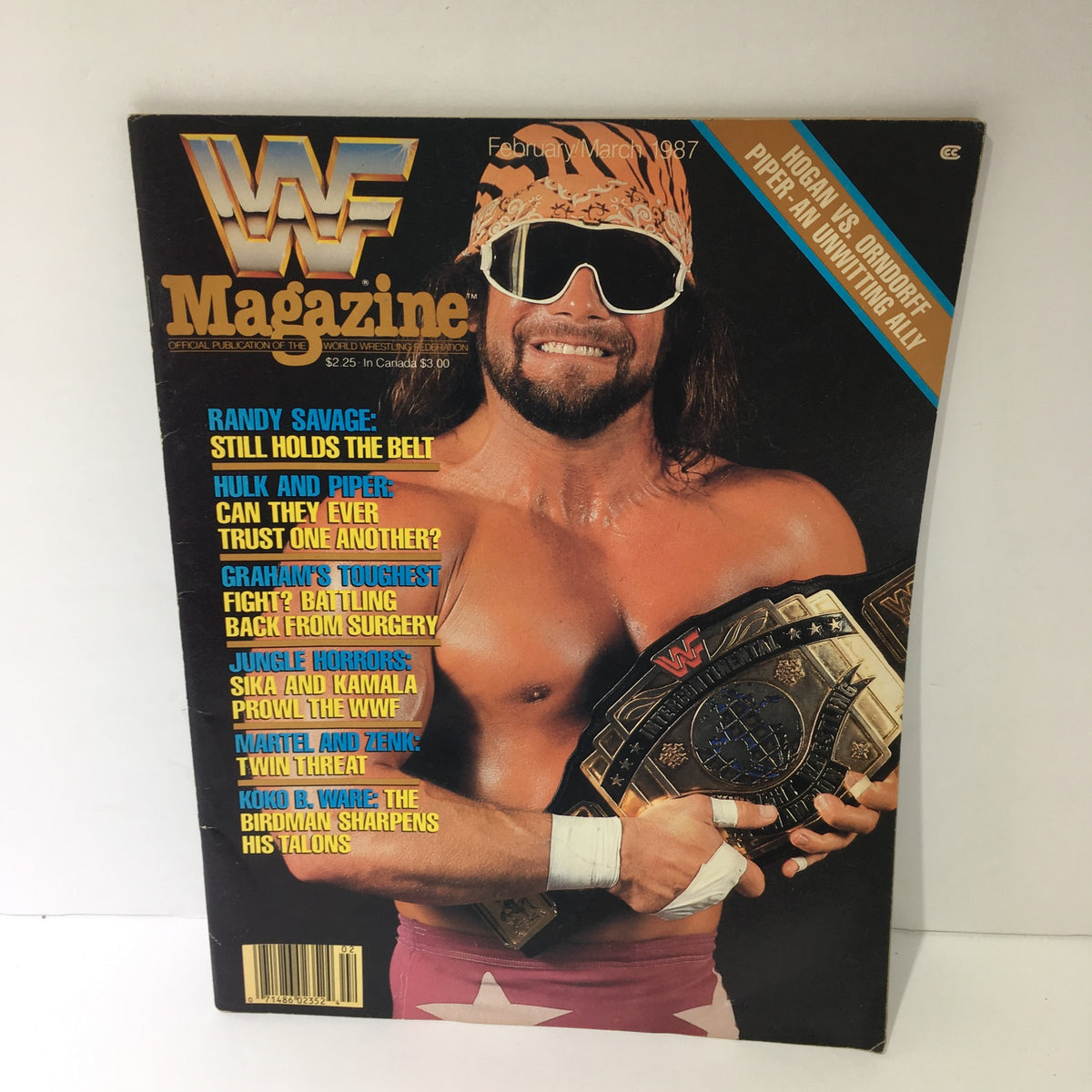 WWF Magazine cover featuring Randy Savage, showcasing the title 'Randy Savage: Still Holds the Belt' from February/March 1987, highlighting wrestling themes.