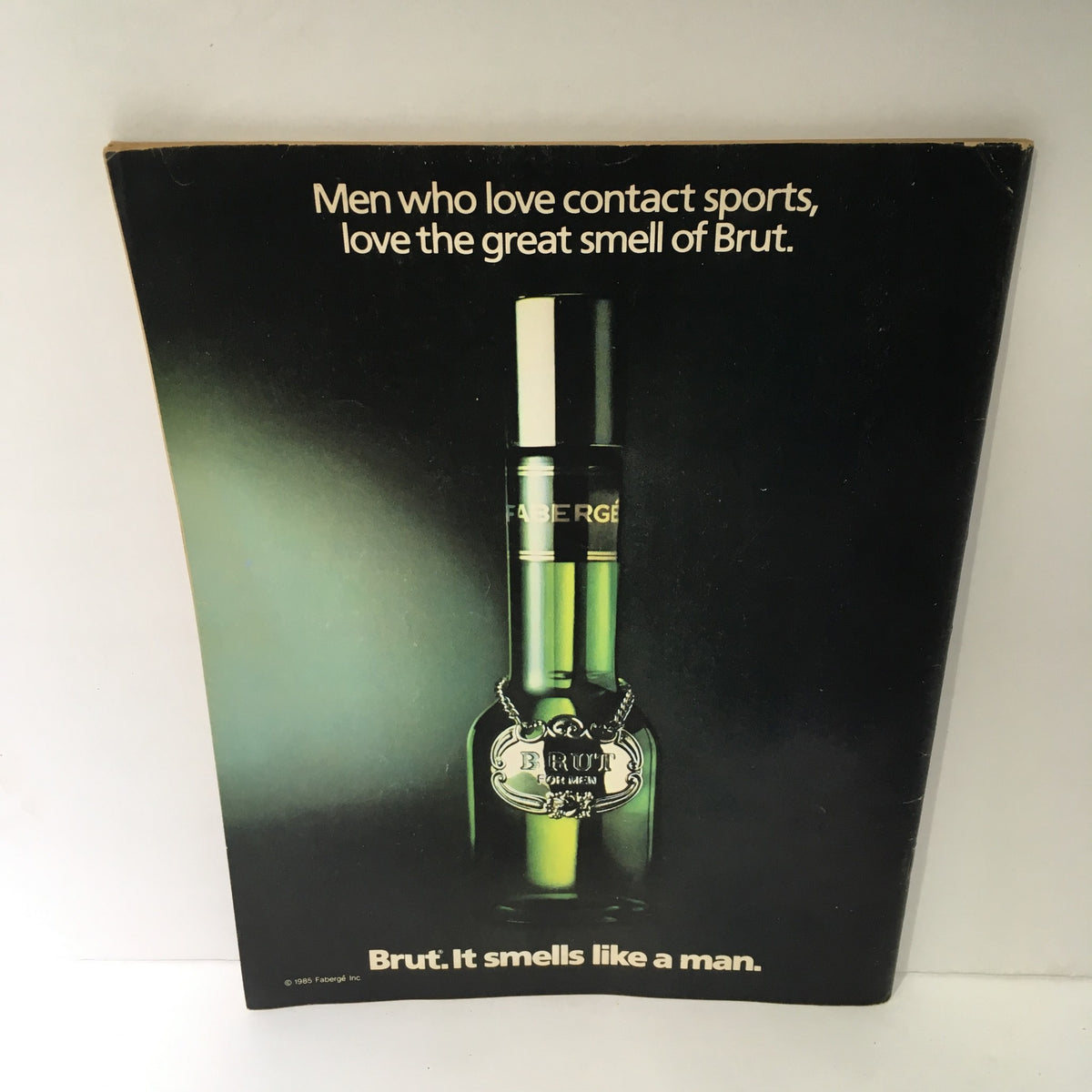 Back cover of the WWF Magazine from February/March 1987 titled 'Randy Savage Still Holds the Belt,' featuring an advertisement for Fabergé's Brut fragrance.