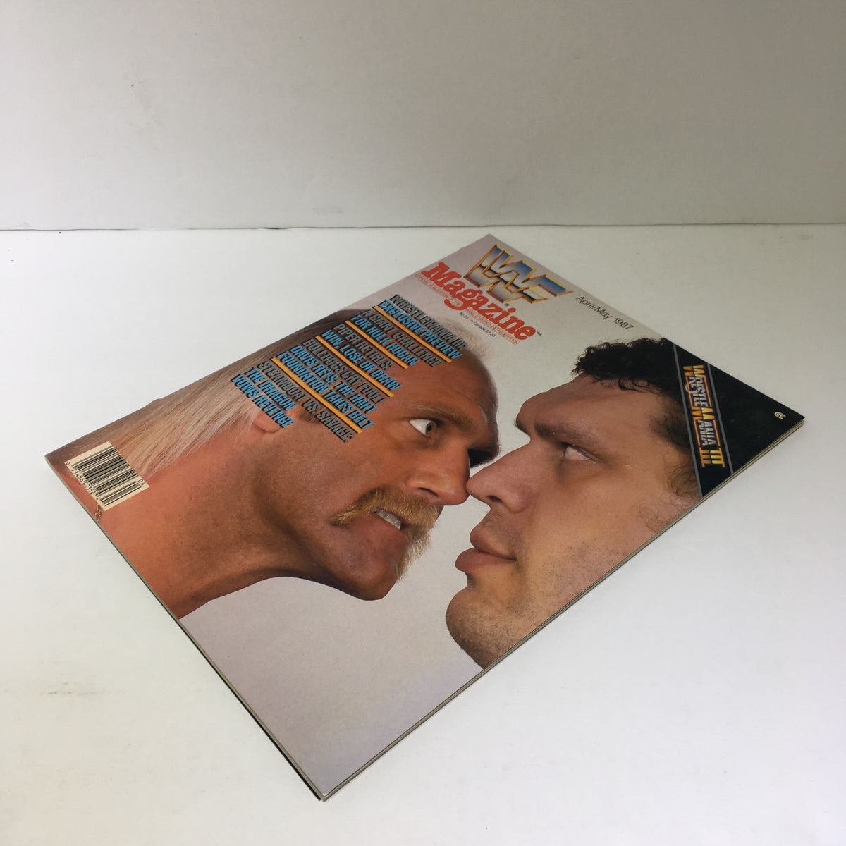 Side view of WWF Magazine featuring Hulk Hogan and Andre the Giant, with the edition date 'April/May 1987' prominently displayed.