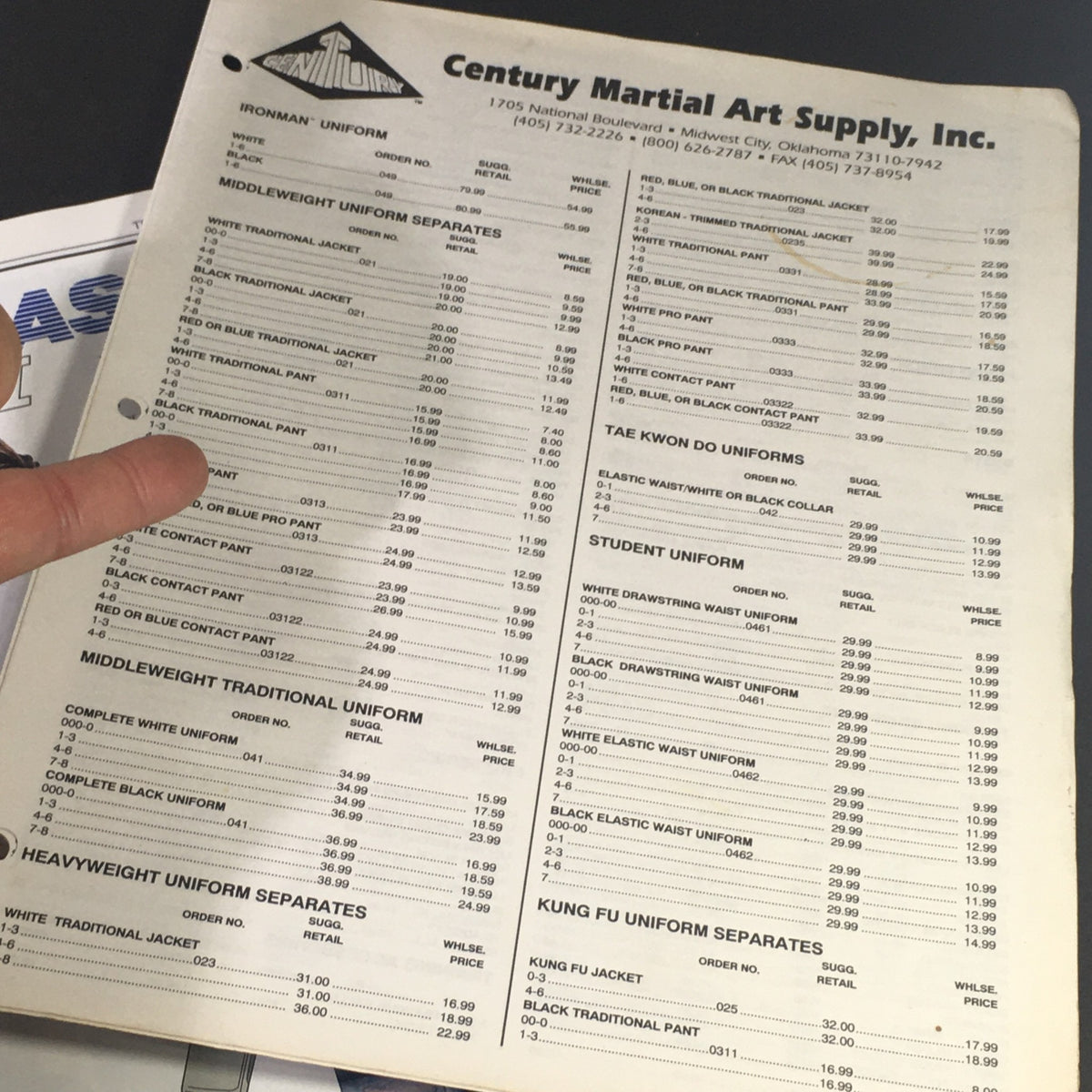 Inside page of the Century Martial Art Supply Inc. Sale Catalog Summer 1995 showing a list of martial arts uniforms and their prices.