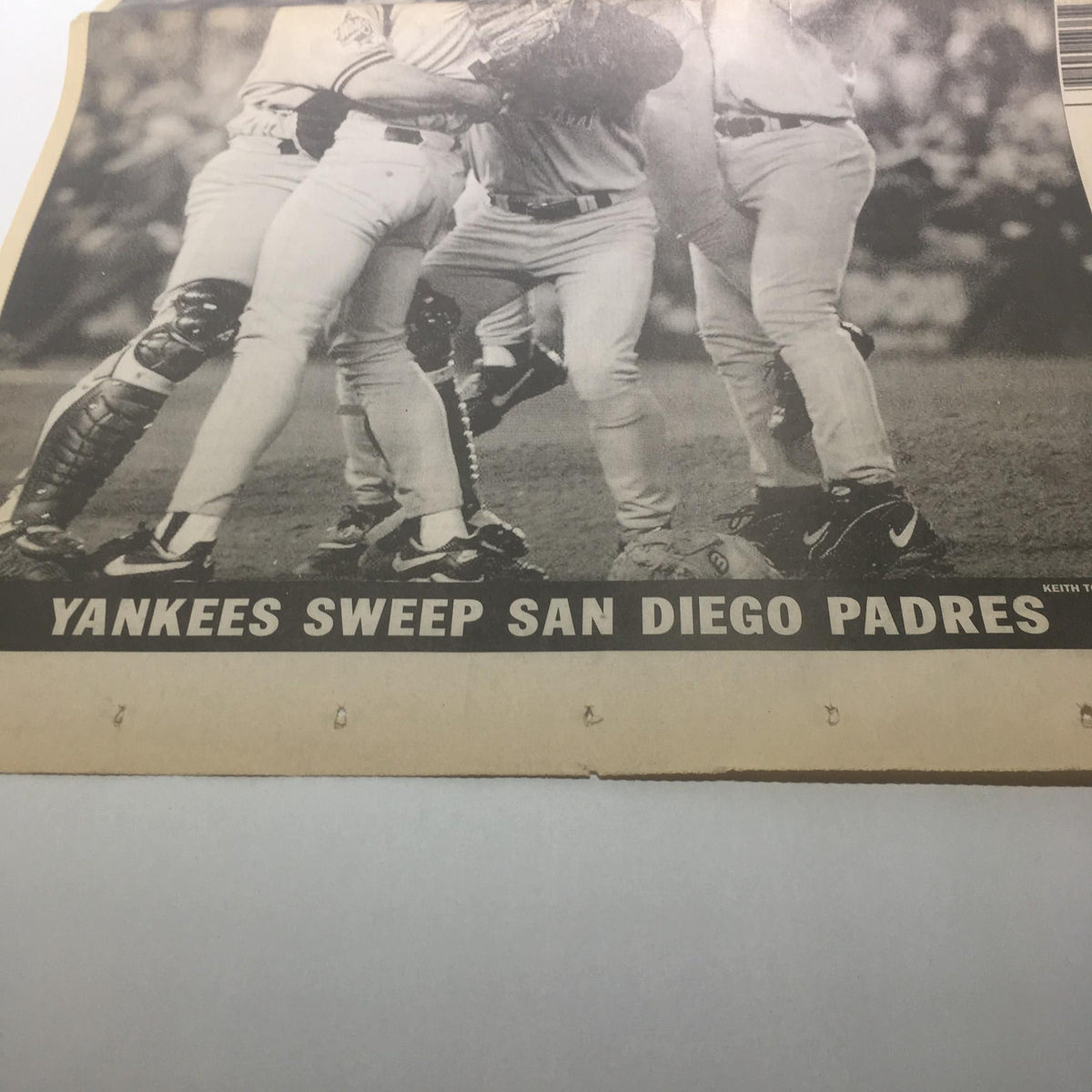 Photograph from the New York Daily News that captures the moment when the Yankees swept the San Diego Padres in the 1998 World Series, featuring prominent headlines.