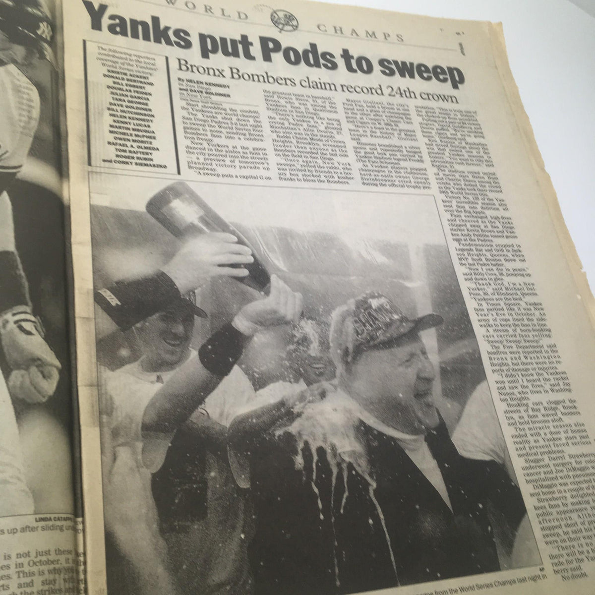 Celebratory image from the New York Daily News, depicting Yankees players celebrating their 1998 World Series victory over the San Diego Padres after a historic sweep.