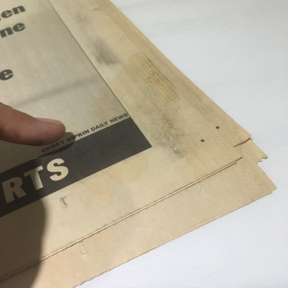 Close-up view of a vintage newspaper page from NY Daily News dated 4/19/99, featuring Wayne Gretzky's tribute. The image shows the edge of the newspaper with noticeable wear and tear.