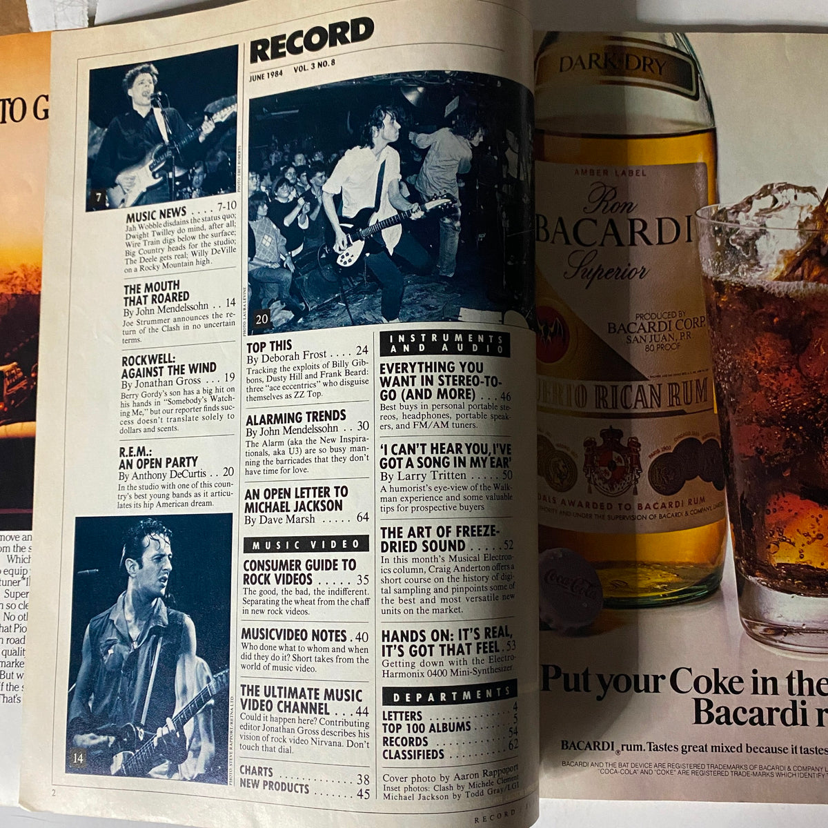 Inside page of Record Magazine June 1984, Vol 3 No. 8, featuring music news, articles on Michael Jackson, and images of popular bands like R.E.M. and The Clash.