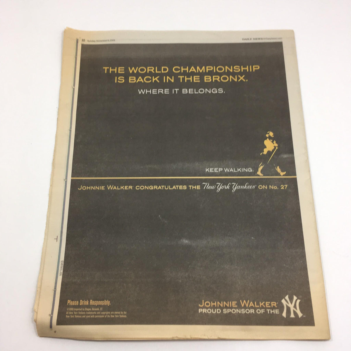 Advertisement from the NY Daily News commemorative issue titled 'Road to Glory: A Commemorative Look at the 2009 Yanks Season', featuring Johnnie Walker's message about the New York Yankees.