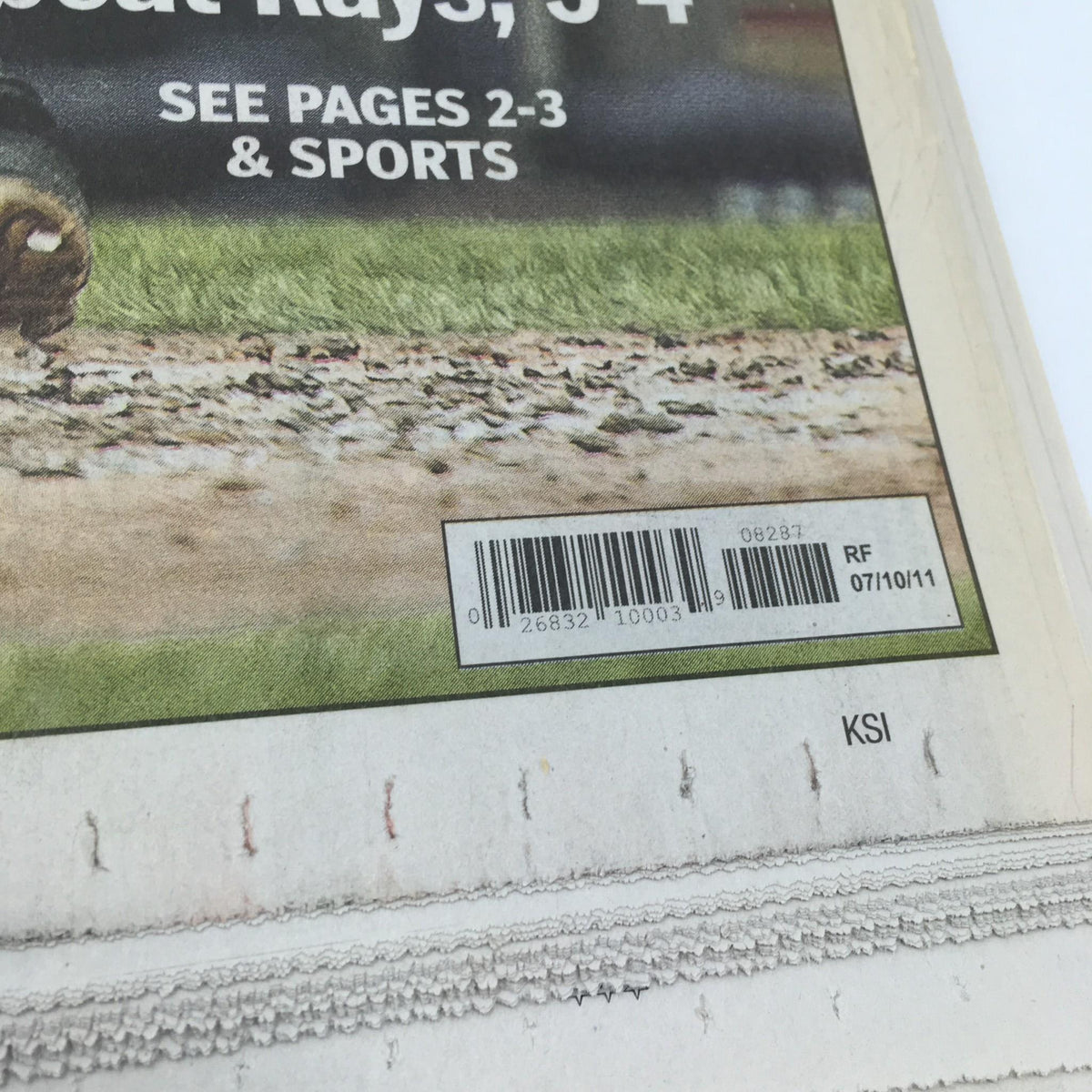 Close-up of the barcode and publication date on the New York Daily News from July 10, 2011, affirming its authenticity and historical significance related to Derek Jeter.